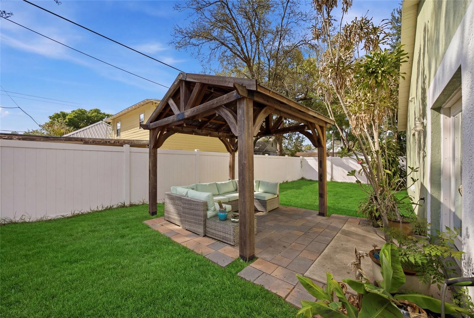 Pergola and pavers. Outdoor furniture conveys.
