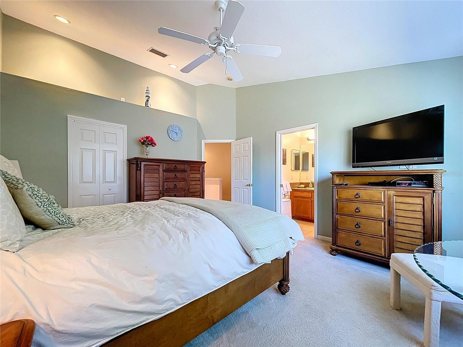 The Primary bedroom is spacious with vaulted ceilings and a large walk-in closet.