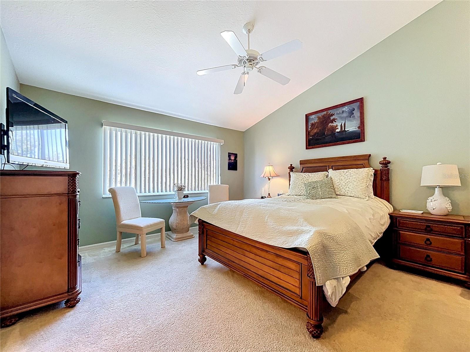 The Primary bedroom is spacious with vaulted ceilings and a large walk-in closet.