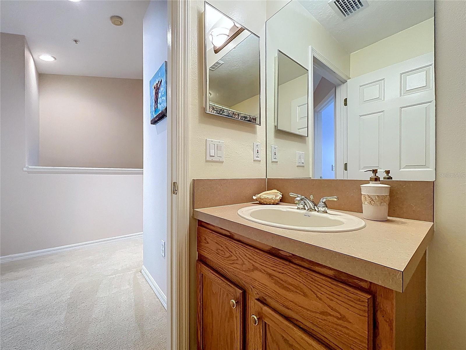 Second floor laundry closet is conveniently located between the bedrooms.