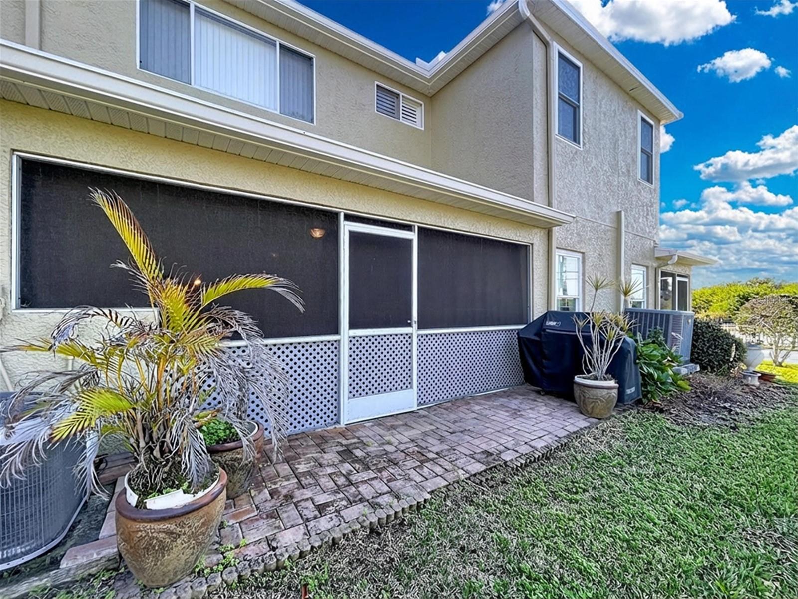 The rear screened patio offers an outdoor space to take in the Florida warm air.