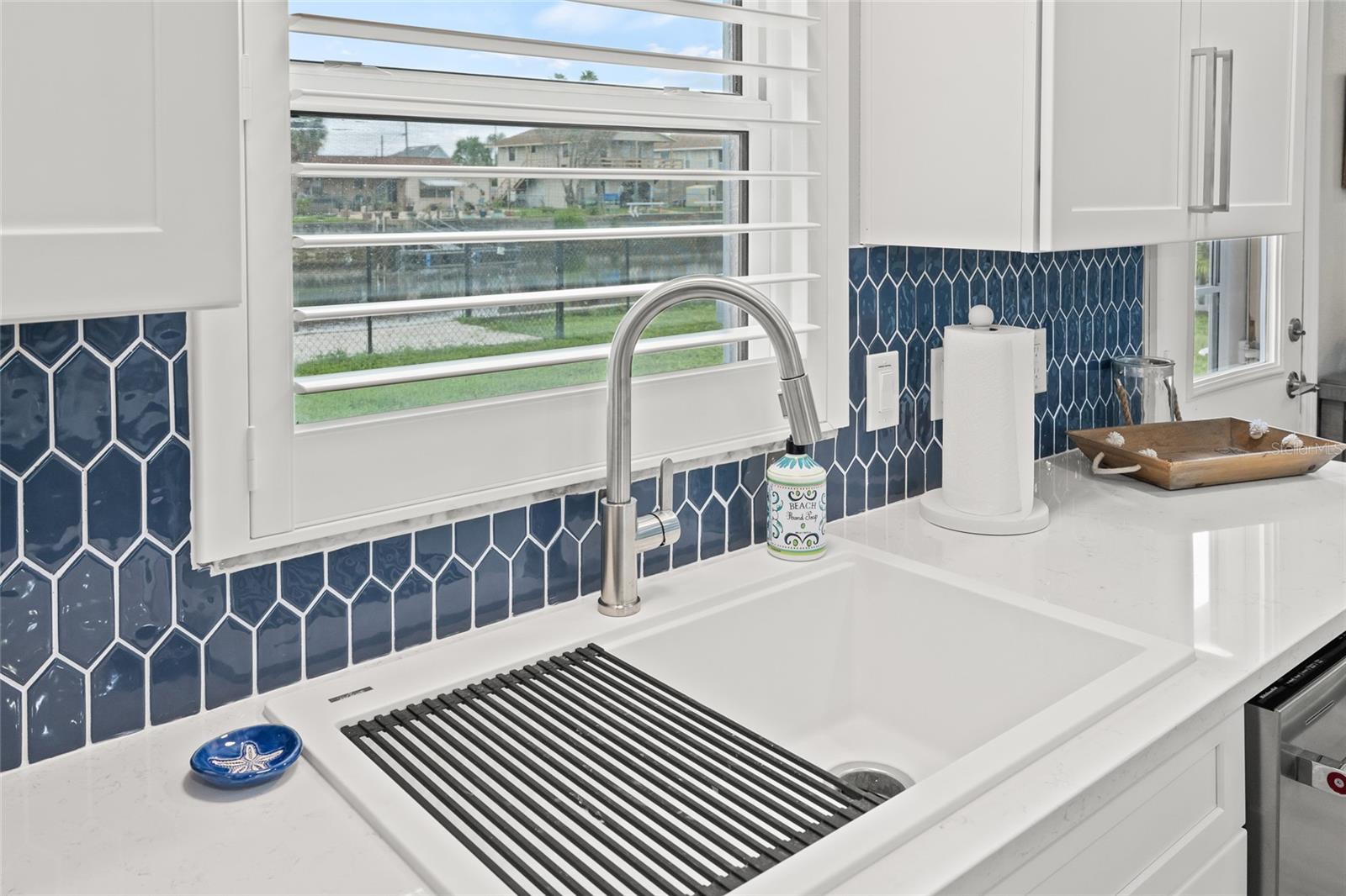 White Composite Sink with Window Views to Canal in Back