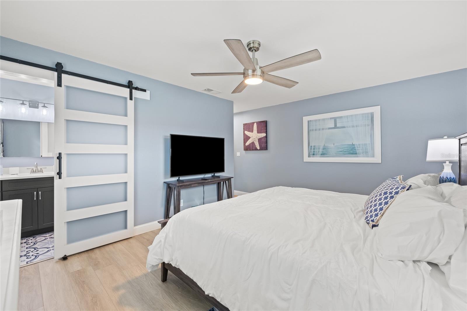 Primary Bedroom with Farm Door to Primary Bathroom