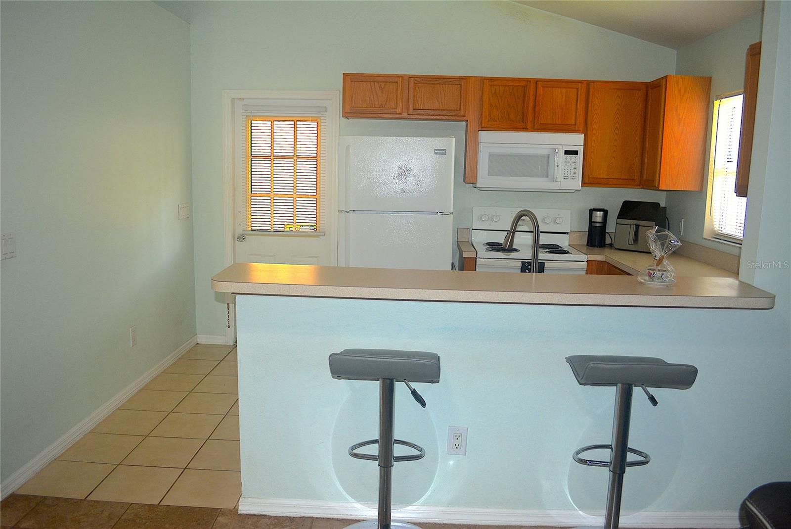 Kitchen with Door Access to Porch and Backyard