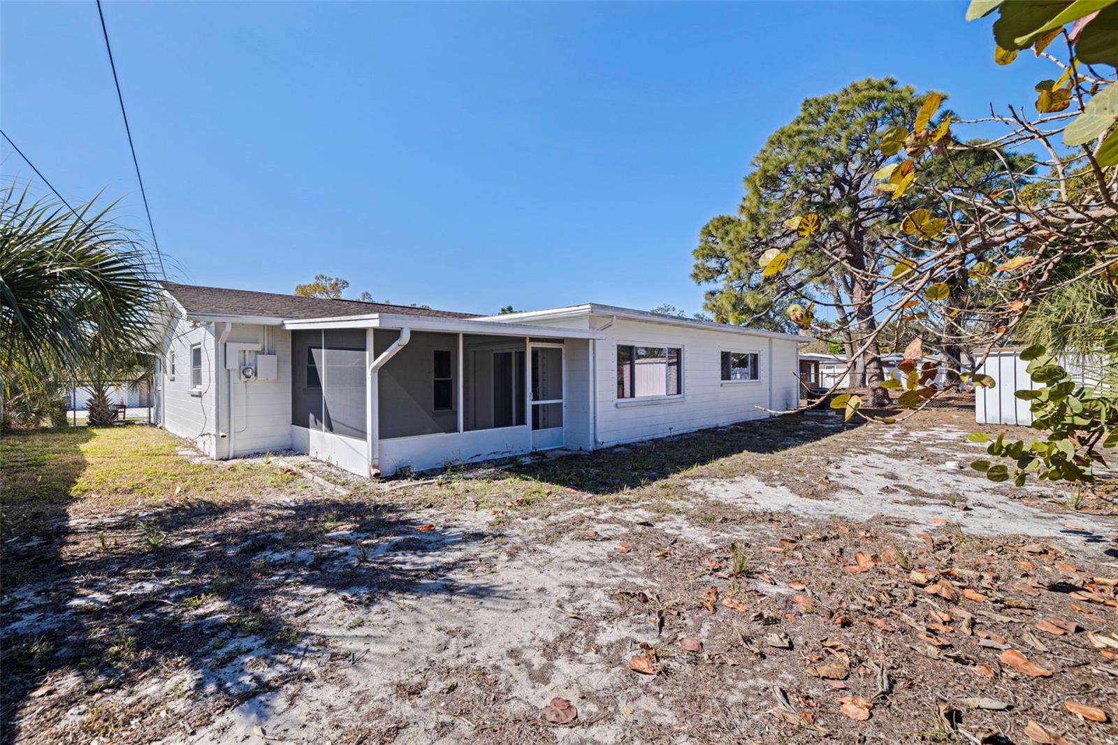 The covered patio offers a shaded space for relaxing or outdoor dining, while the large yard provides room to customize, garden, or create additional outdoor living areas. Detached storage shed included for added convenience.
