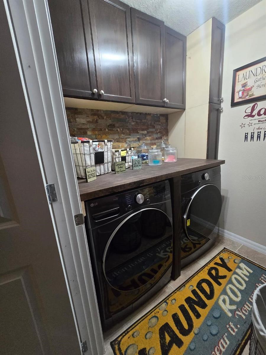 LAUNDRY ROOM WITH CABINETS & COUNTERTOP. W/D LESS THAN 1 YEAR