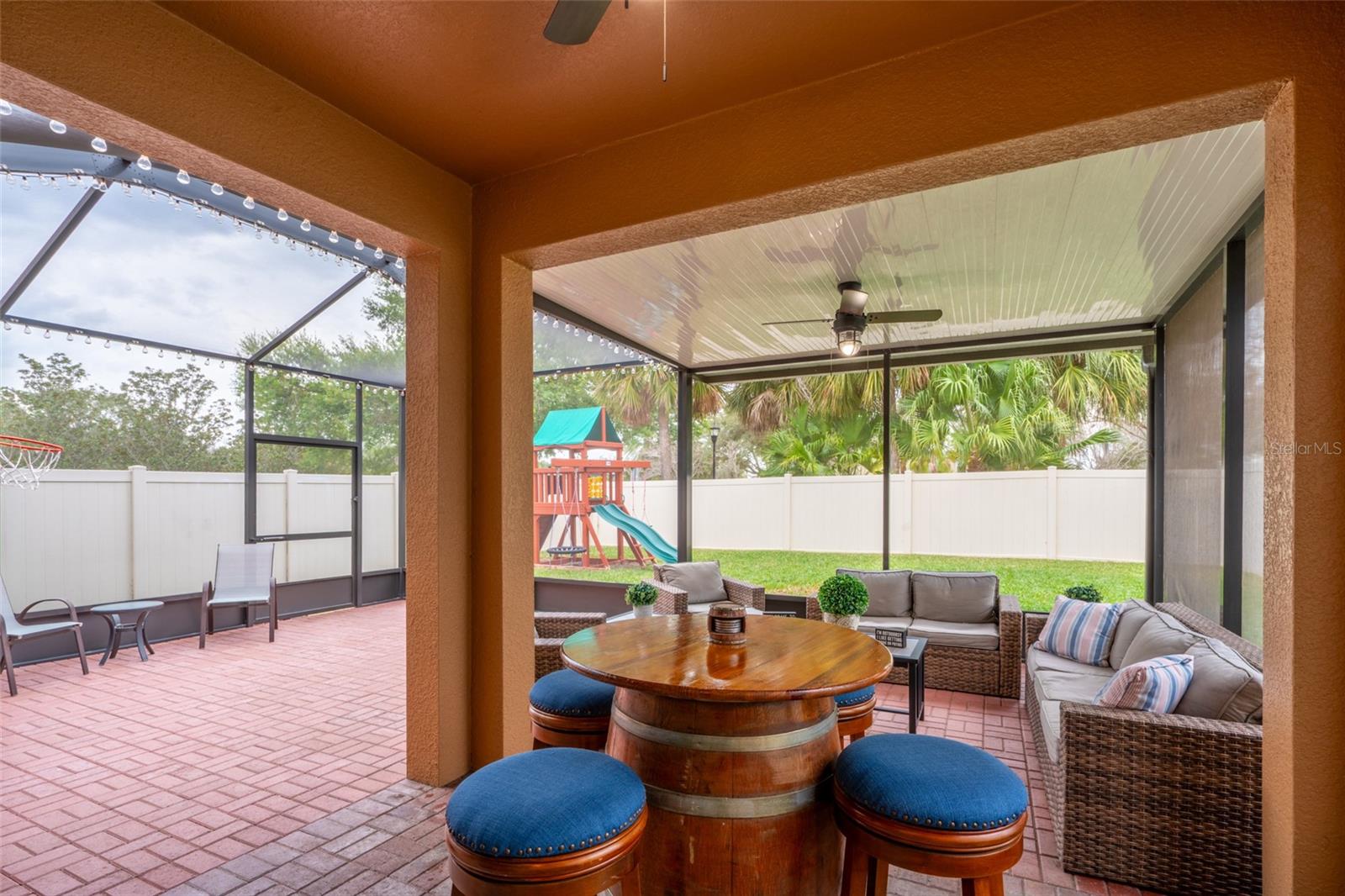 ENJOY SHADE OR SUNSHINE IN THIS EXPANSIVE SCREENED IN LANAI