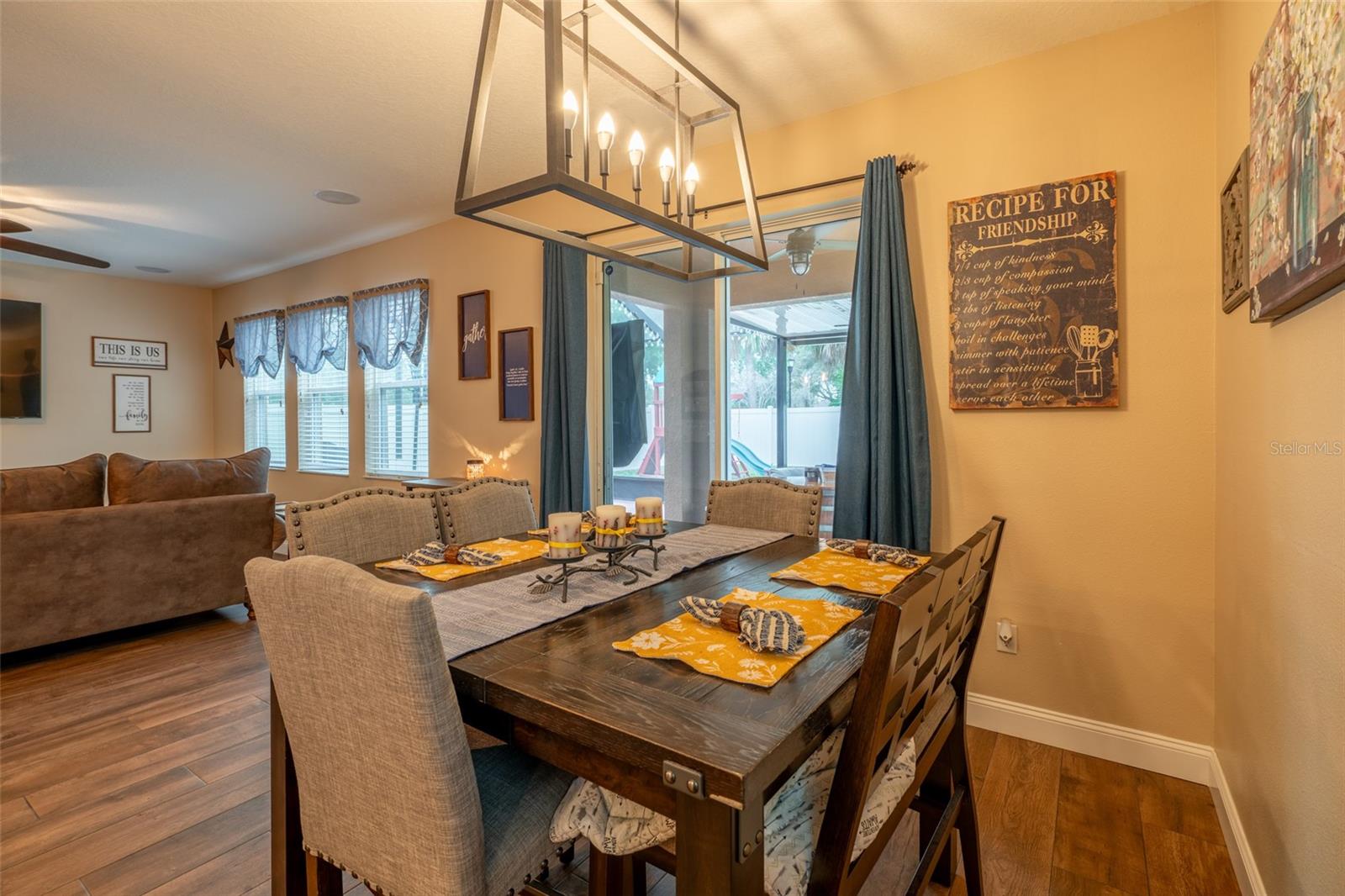 DINING AREA WITH ELABORATE LIGHT FIXTURE