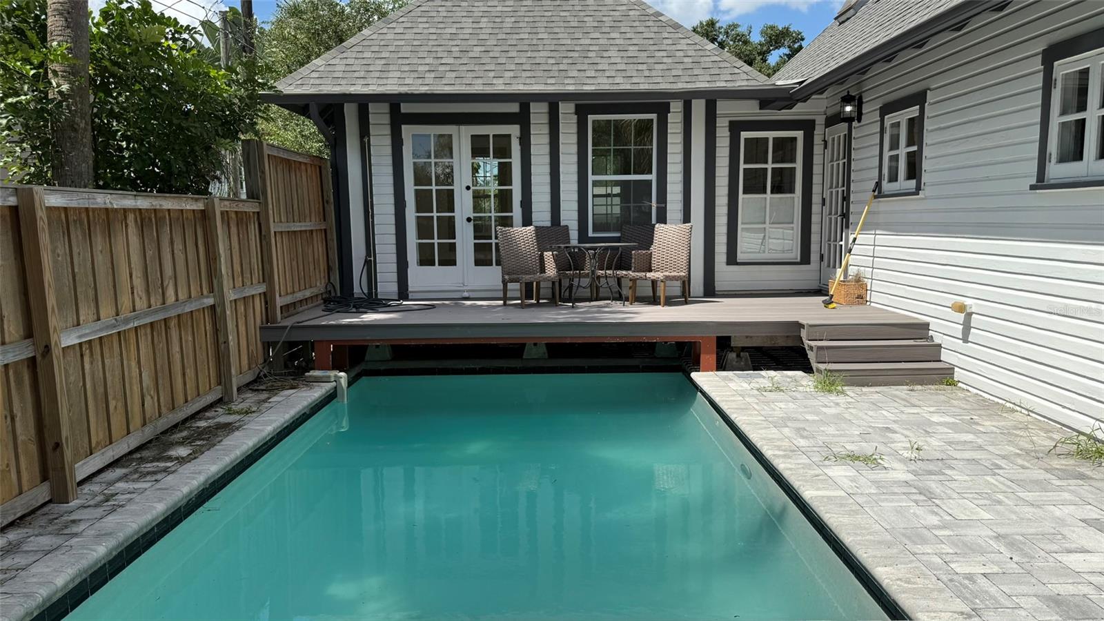 Fenced in Pool Area. new pavers.  pool currently occupies the driveway.