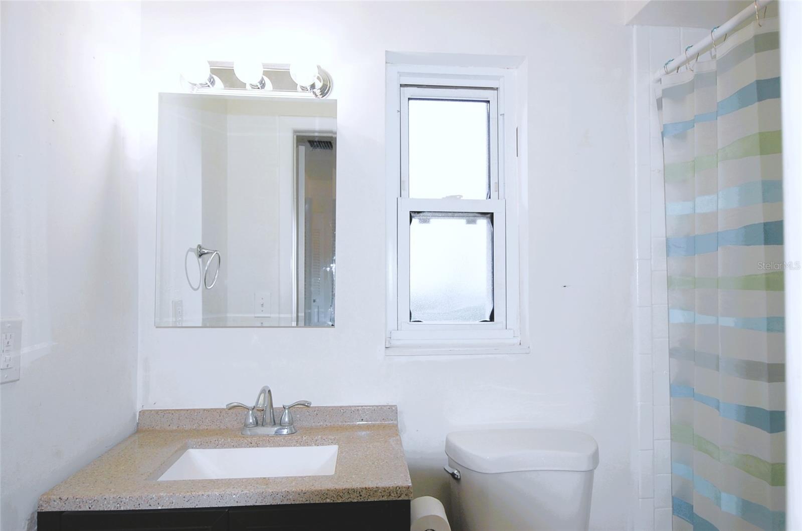 Primary bathroom with updated vanity and a stand up shower