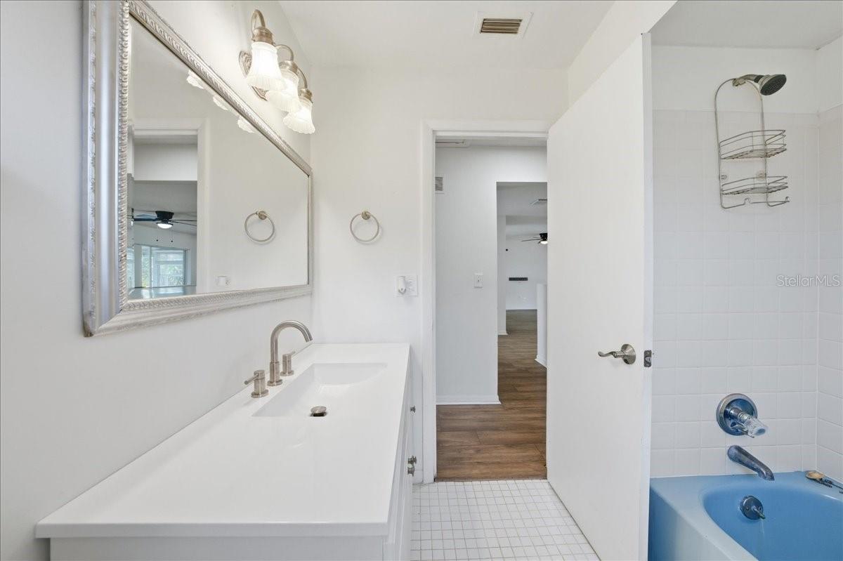 Second bathroom with updated vanity and a shower/tub combination.