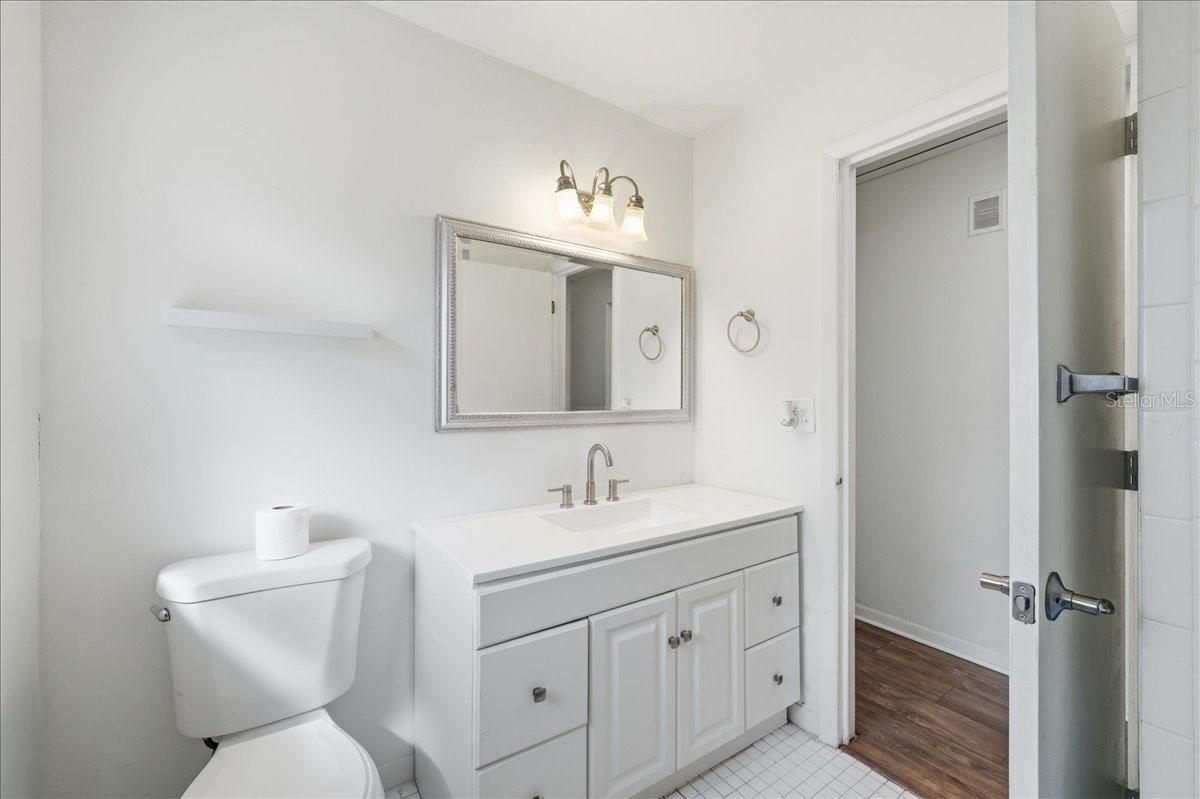 Second bathroom with updated vanity and a shower/tub combination.