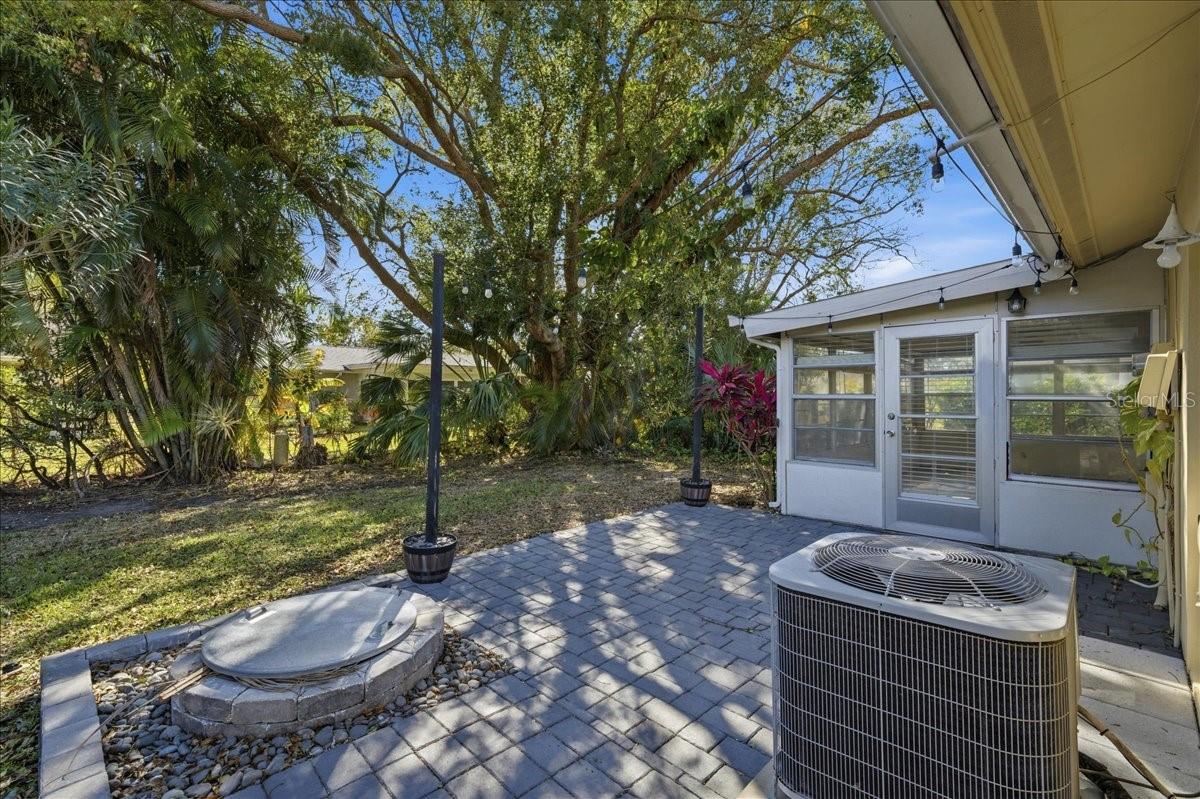 Just outside the lanai in the back yard is a paver patio with firepit providing an inviting outdoor gathering area or space to enjoy the Florida weather year-round.