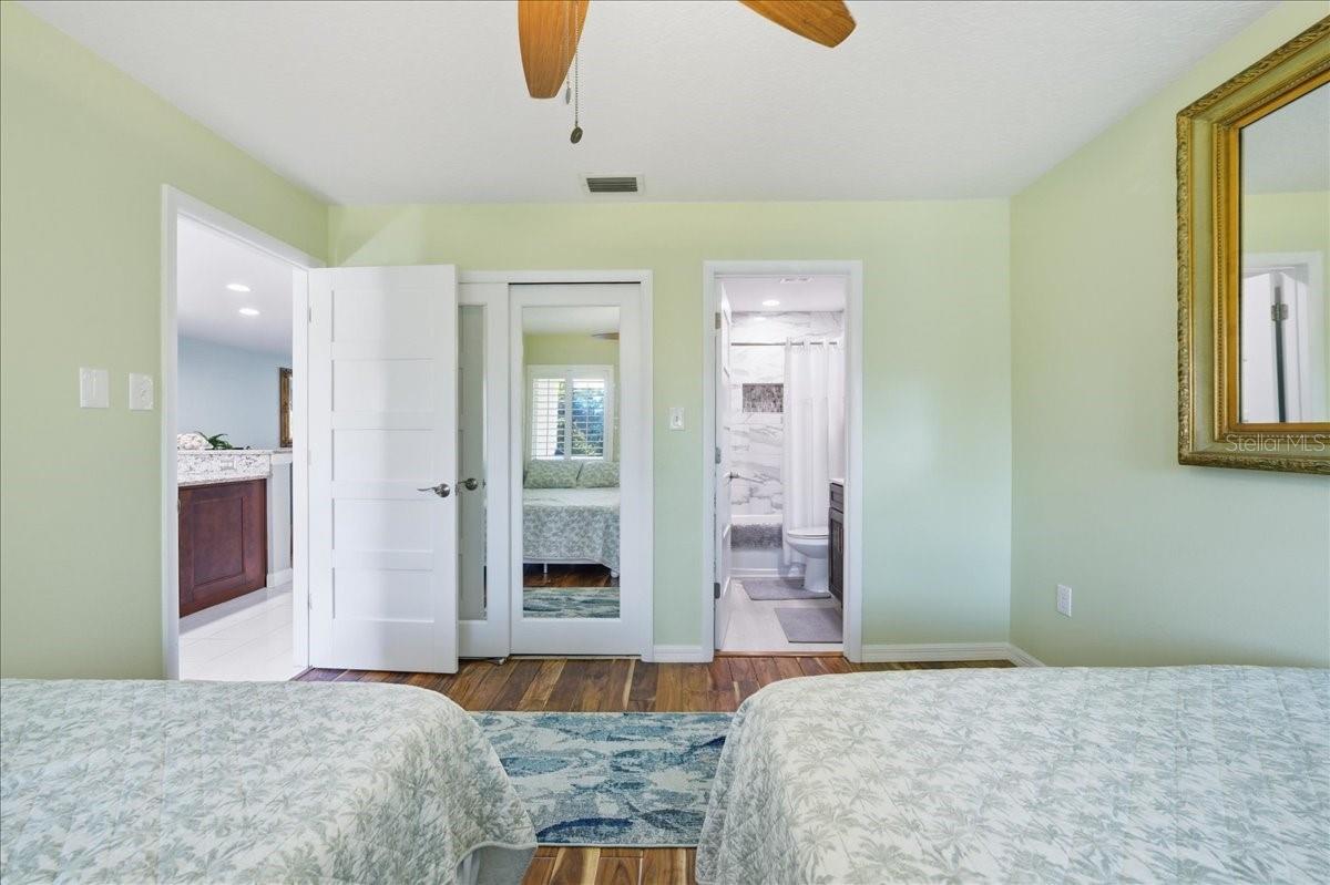 Second bedroom at the front of the unit with its own tastefully updated en-suite bathroom, three windows, beautiful wood-look tile flooring, decorative ceiling fan and California Closet.