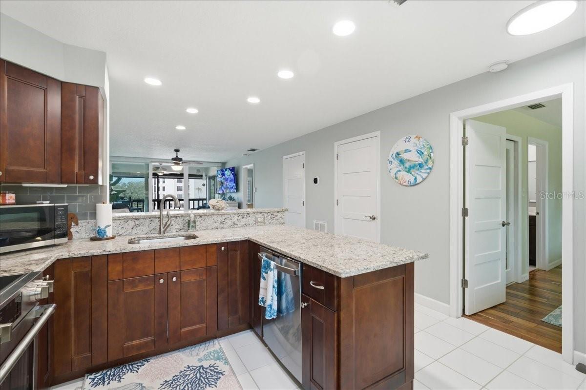 Stunning updated kitchen is well-equipped with stainless-steel appliances including a convection oven, rich cherry wood cabinets with soft closing cabinets and drawers, granite countertops, and beautiful, easy maintenance tile floors that flow into the main living areas.