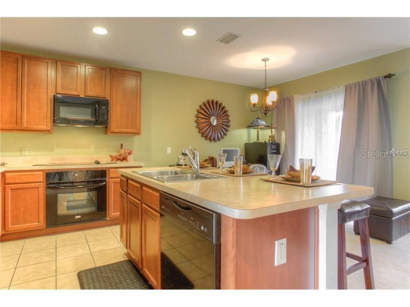 Wood Cabinets, Black Appliances with Island/Breakfast Bar