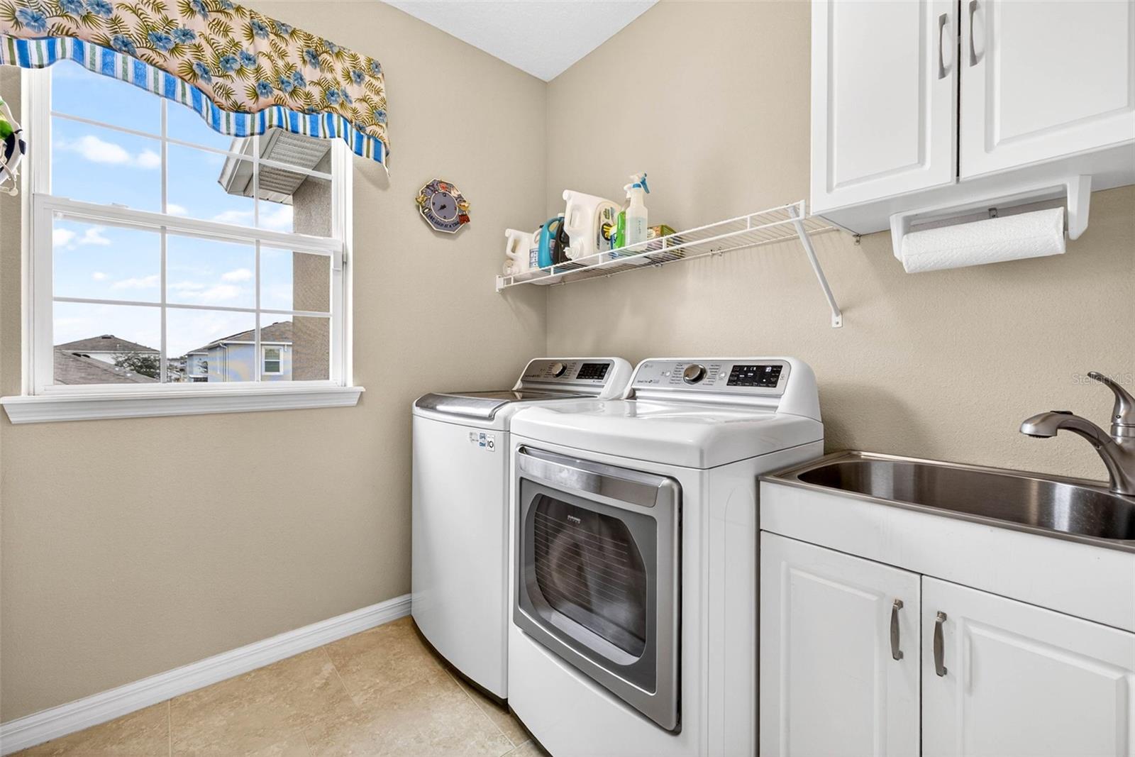 Upstairs laundry room with tub sink