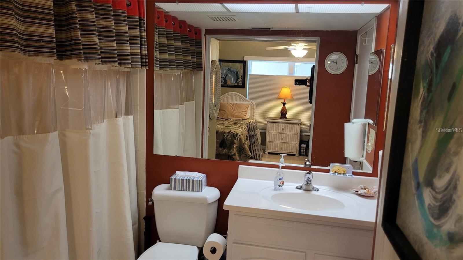 The guest bath has wide pocket door entry from the bedroom making it a suite, plus an entry from the hallway.
