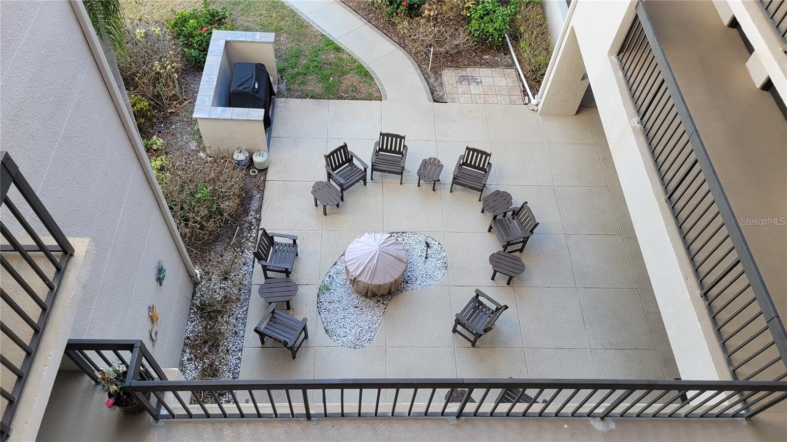 Although you are just steps from condo 318, take a look over the walkway, to view the firepit and grill area (a frequent gathering place for neighbors).