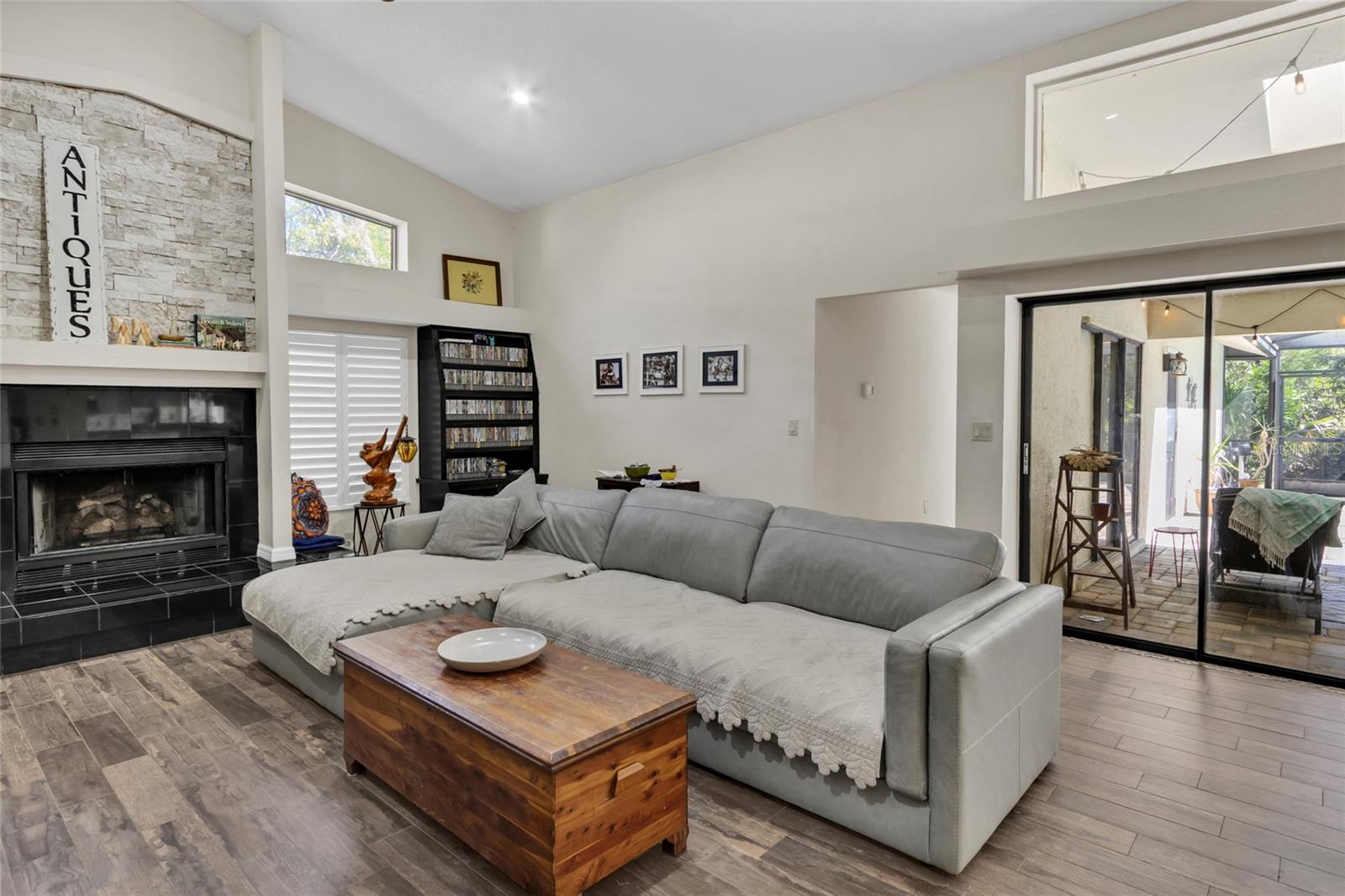 family room with triple slider to pool deck