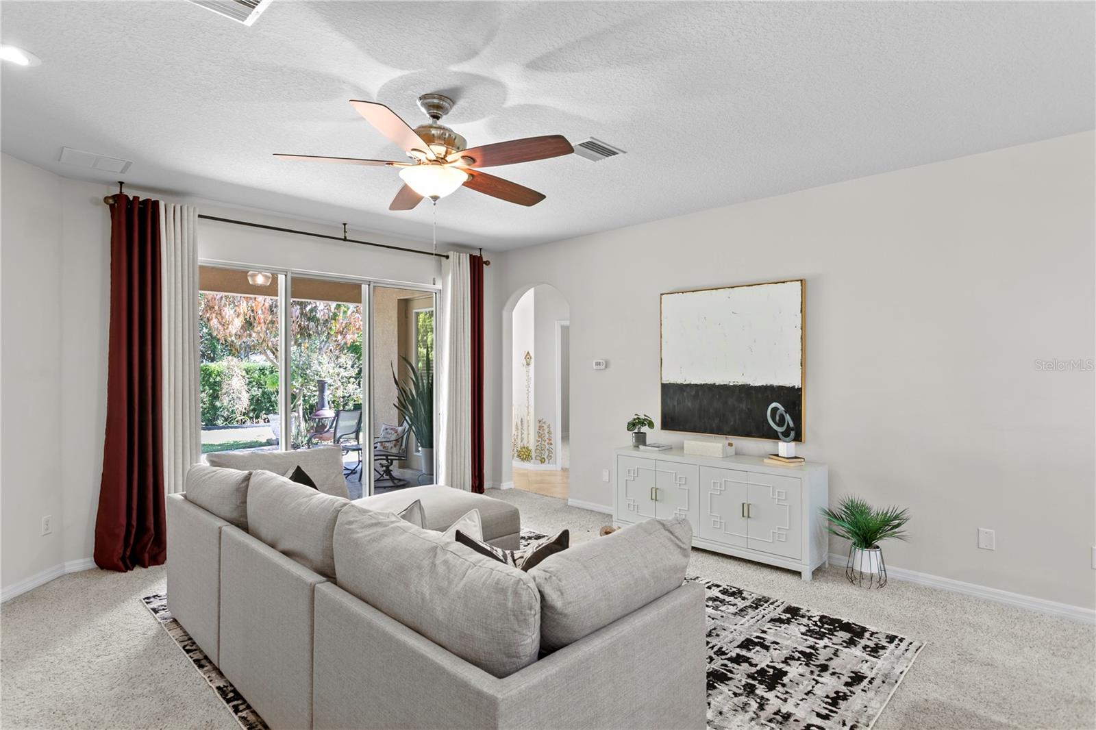 Large family room features sliders to covered lanai