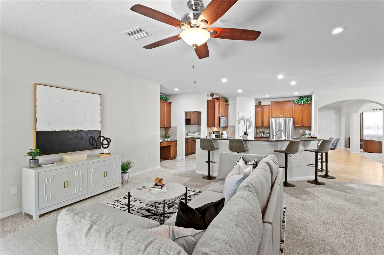 View looking from family room sliding glass doors towards kitchen and living room