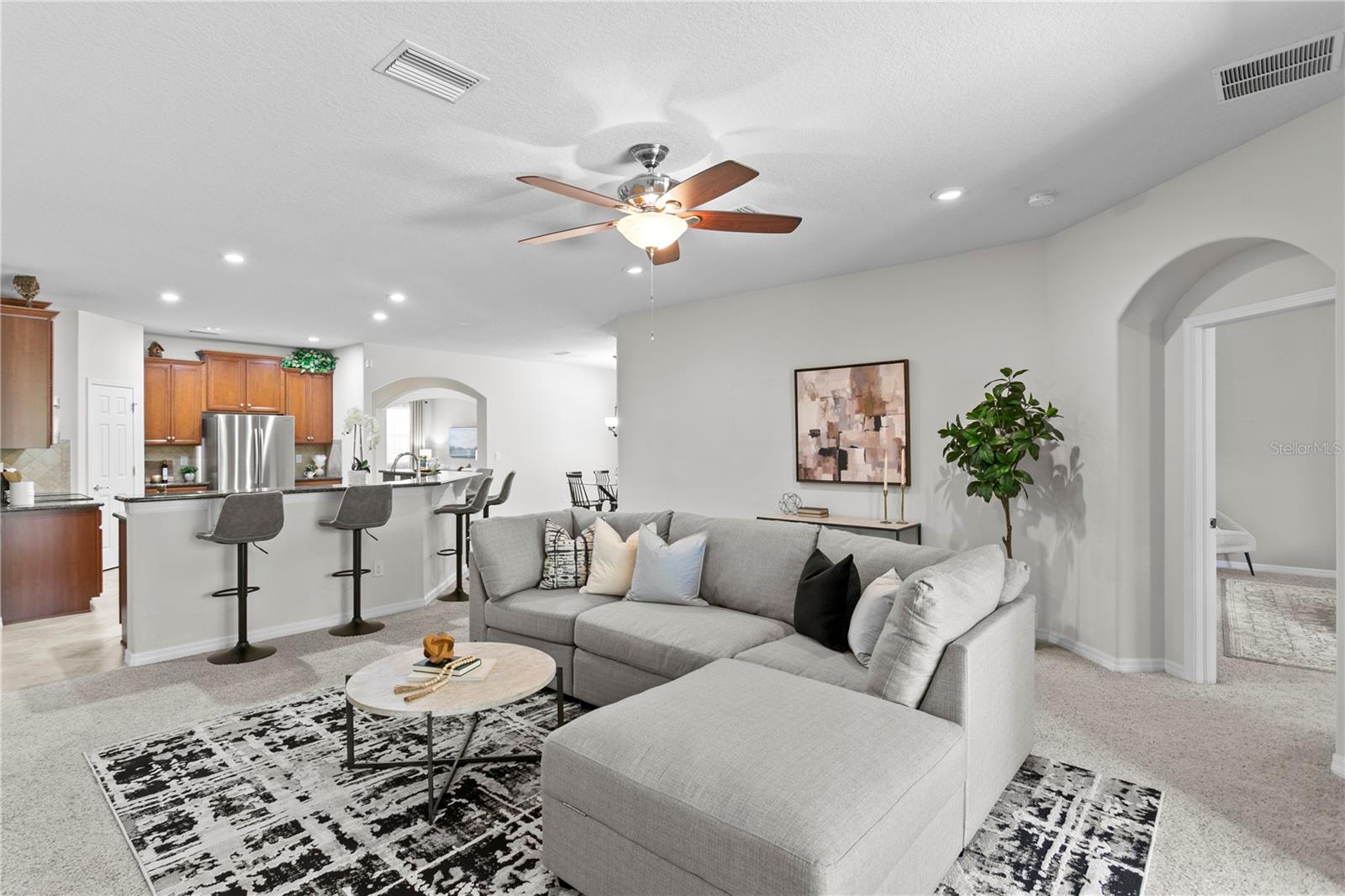 View from sliders to family room and kitchen beyond