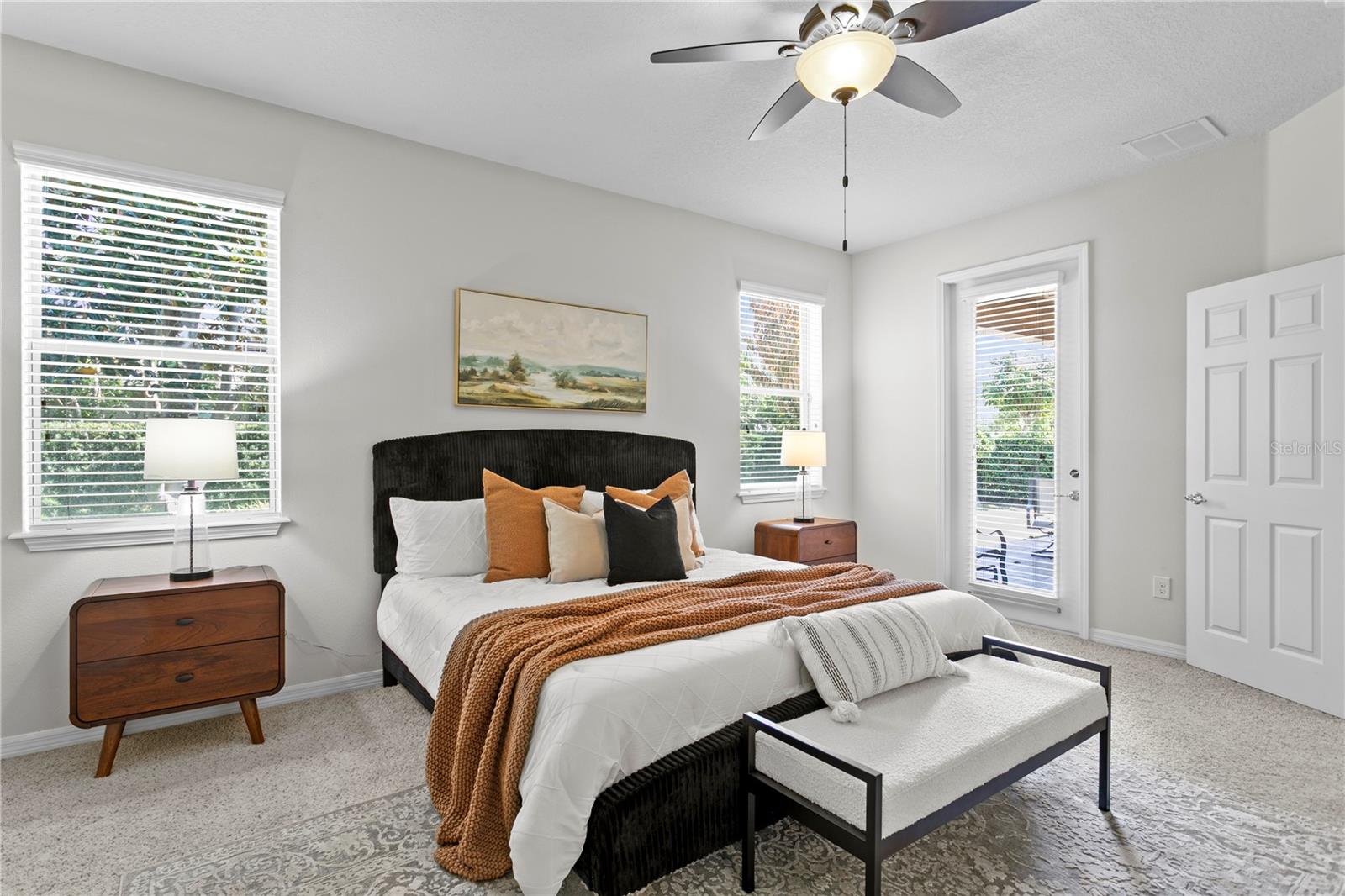 Primary bedroom features exterior door leading to covered lanai