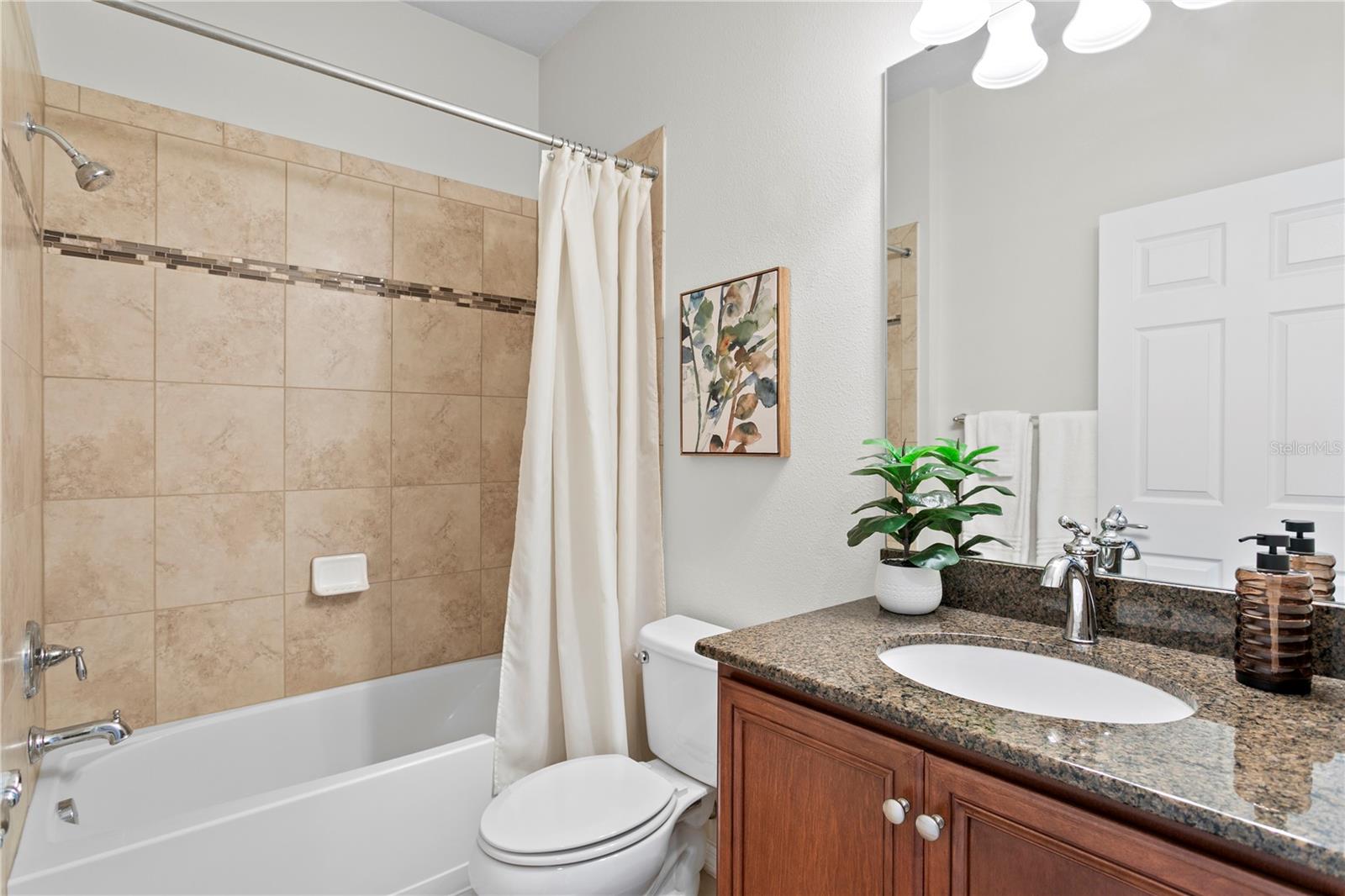 Bathroom 2 features tub/shower combo and granite counters