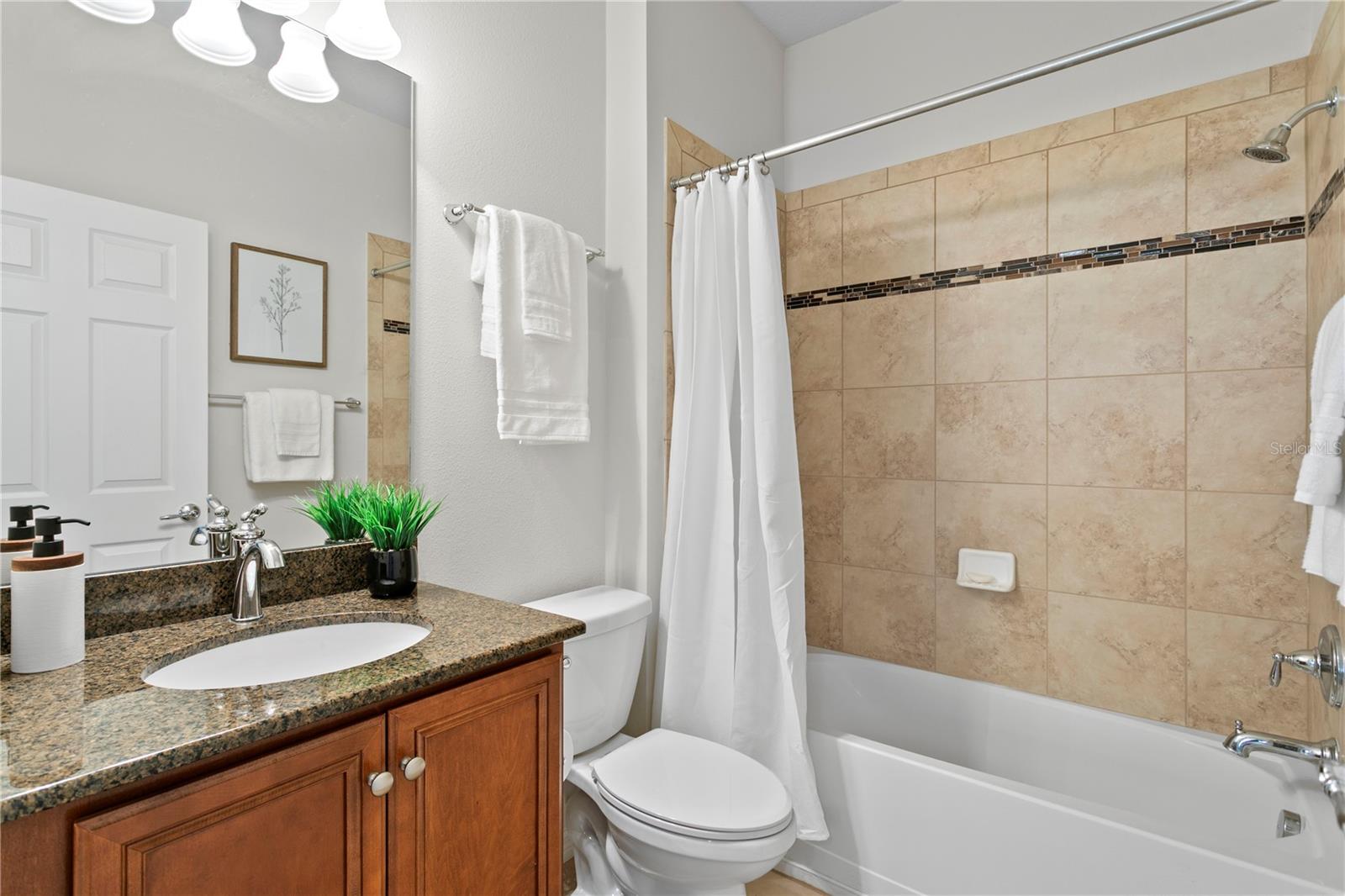 Bathroom 3 features tub/shower combo and granite counters