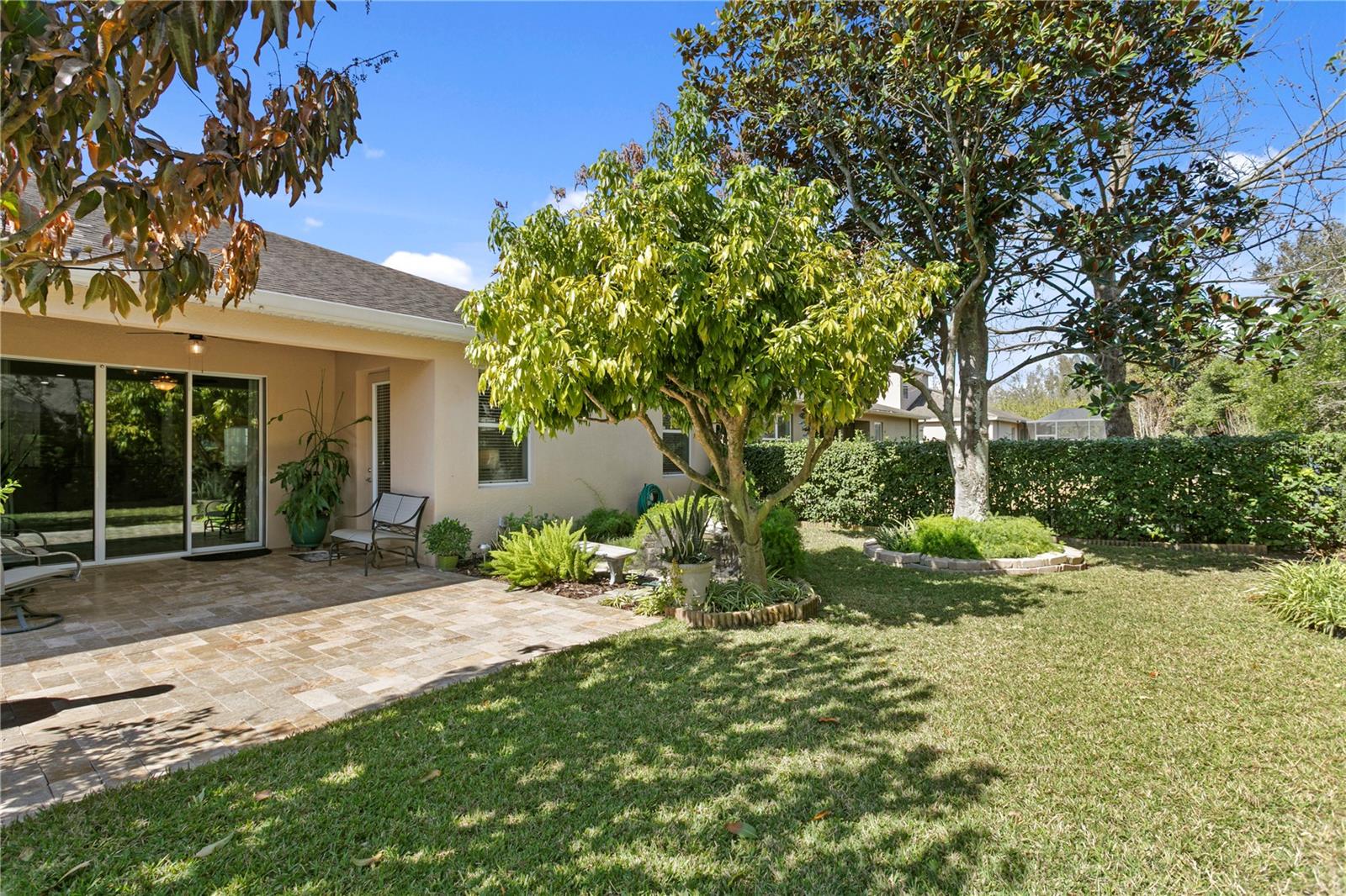 Large mature trees help round out the peaceful backyard retreat