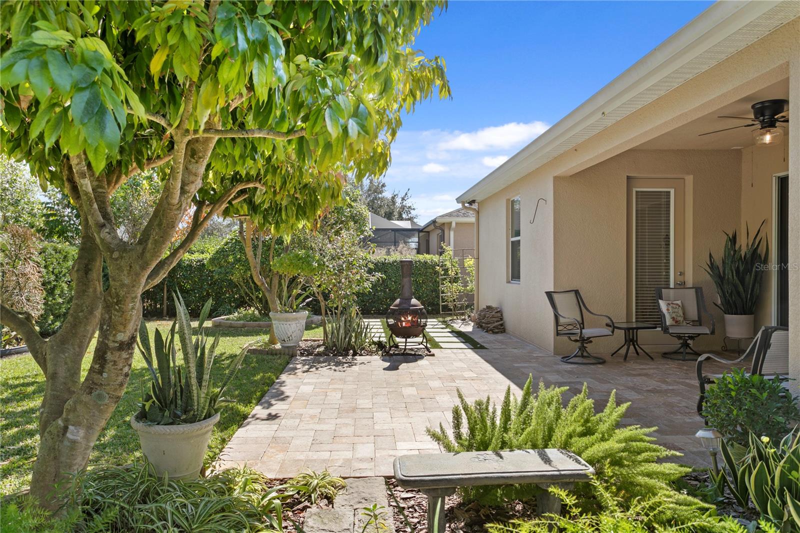 Paver patio with firepit beyond