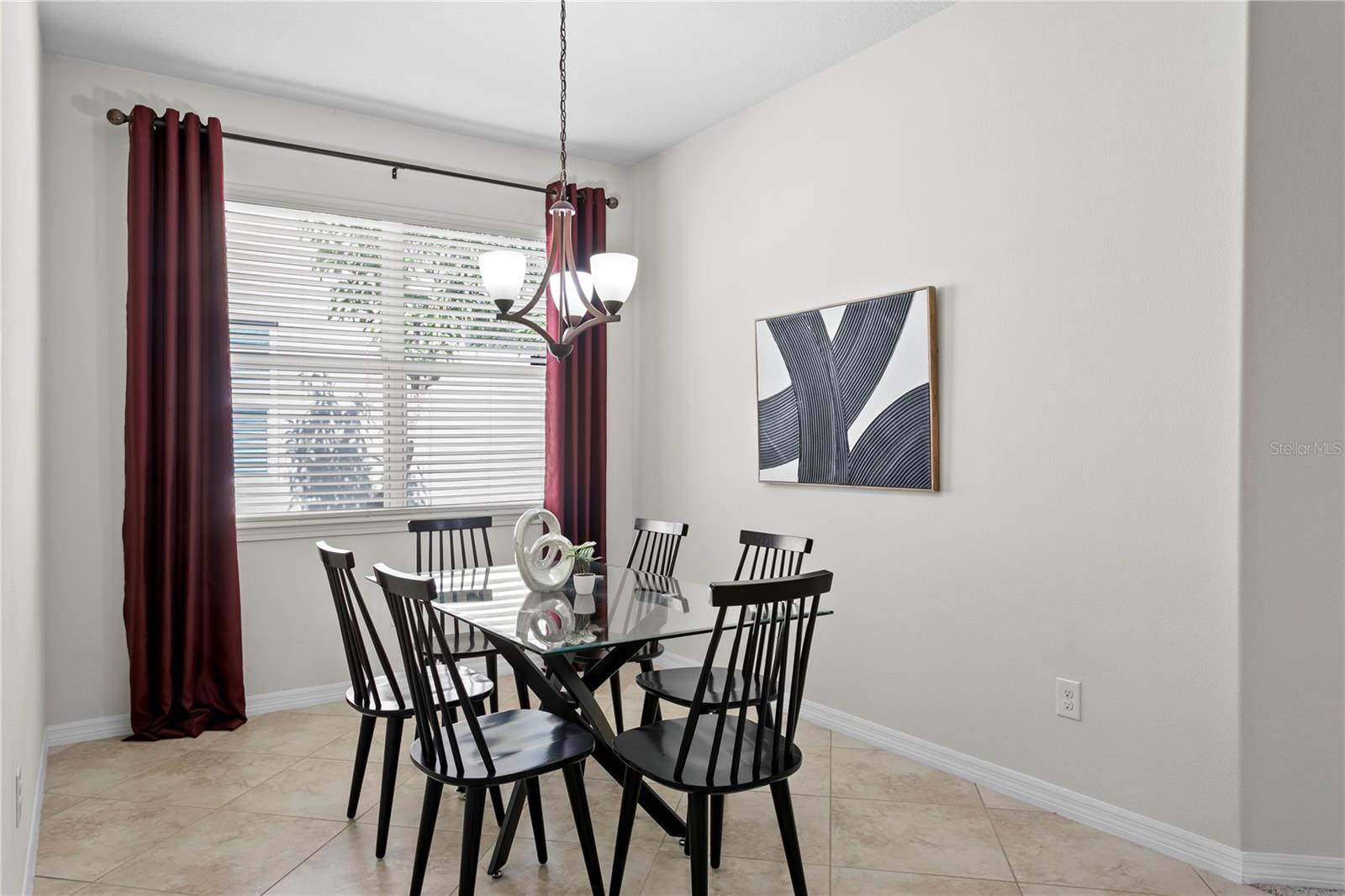 Dinette with ceramic tile flooring adjacent to kitchen
