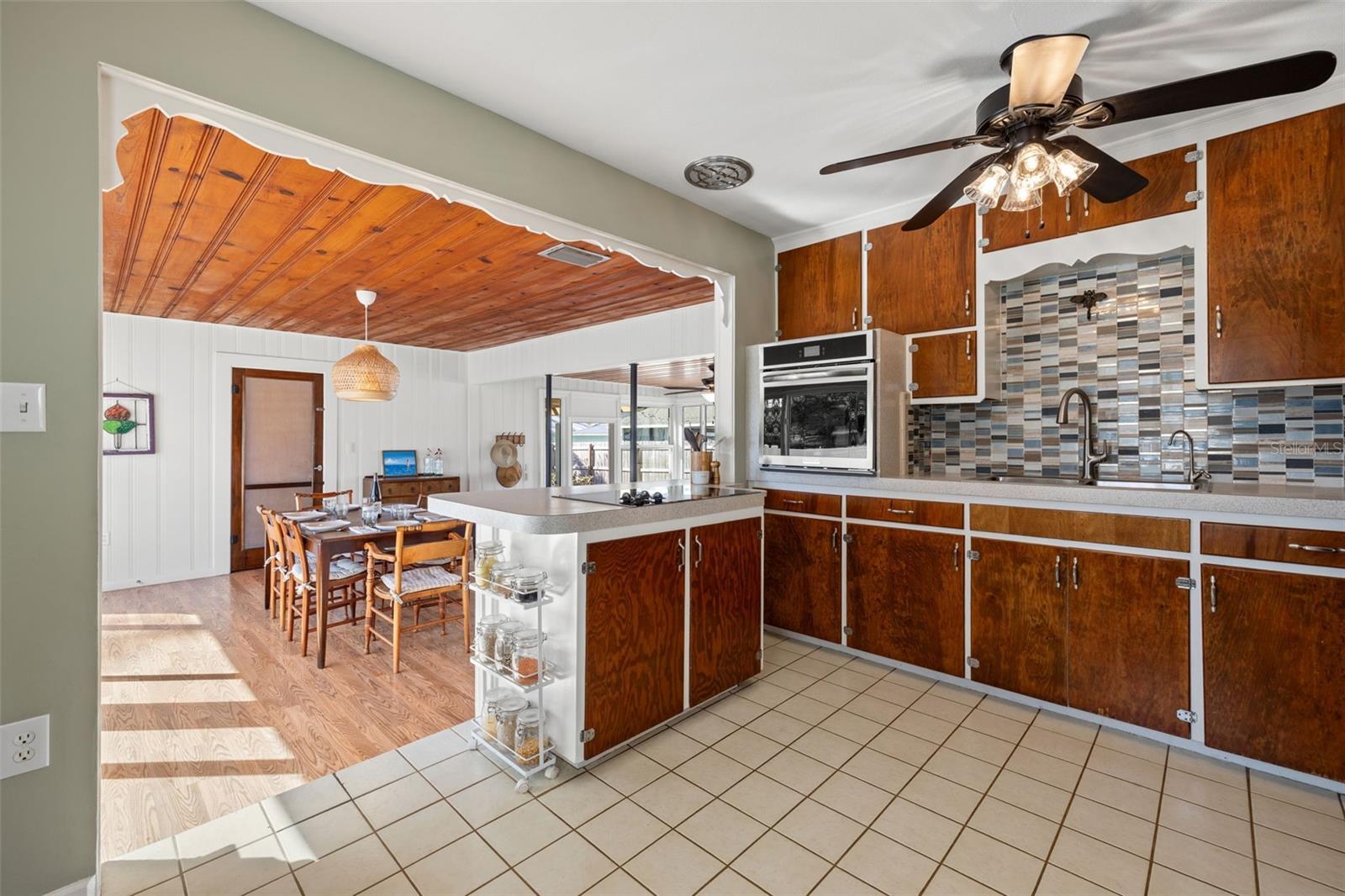 Generous counter space, built-in oven, and decorative tile backsplash provide both style and practicality.