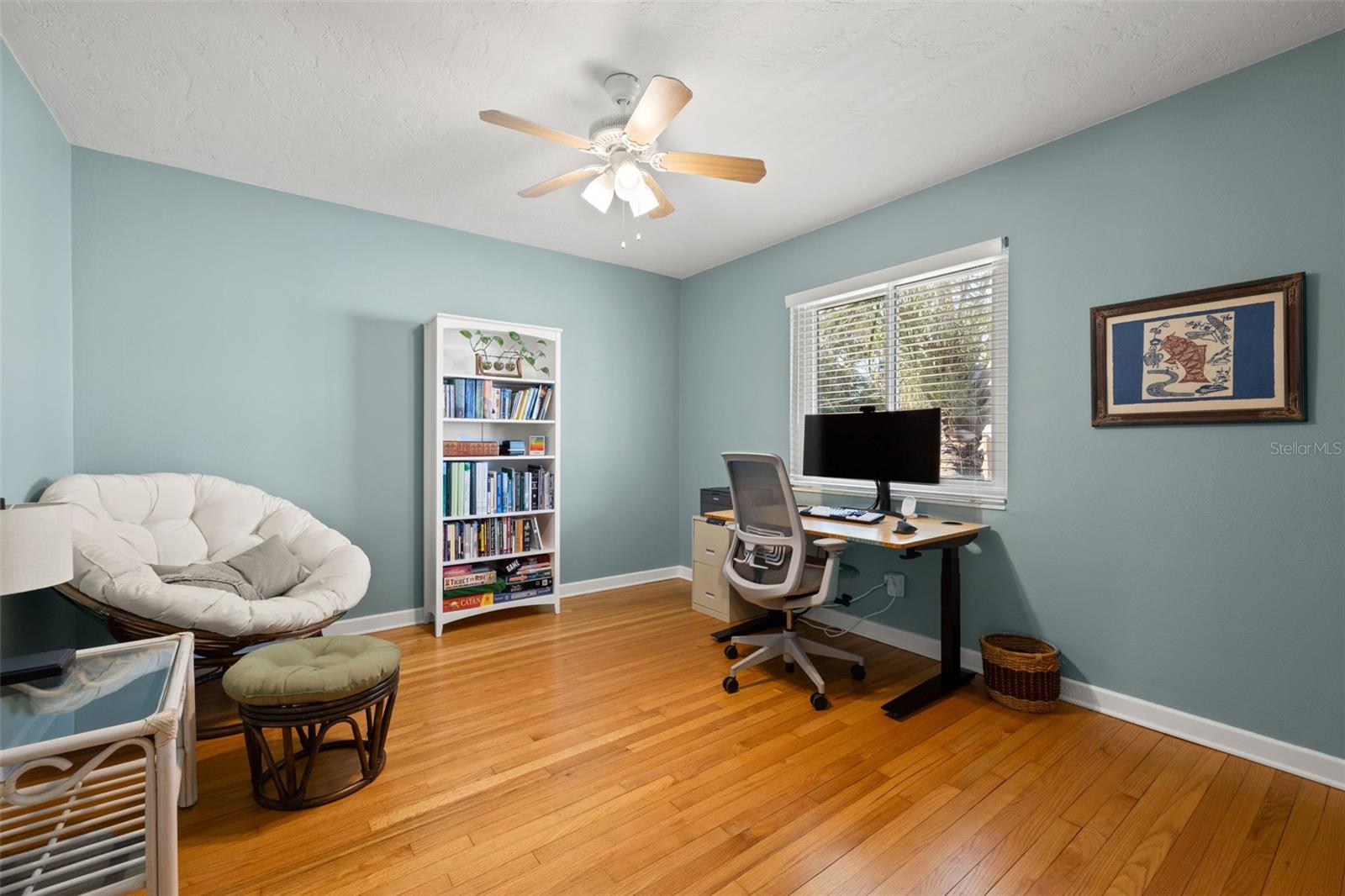 Second bedroom with hardwood flooring and closet storage.