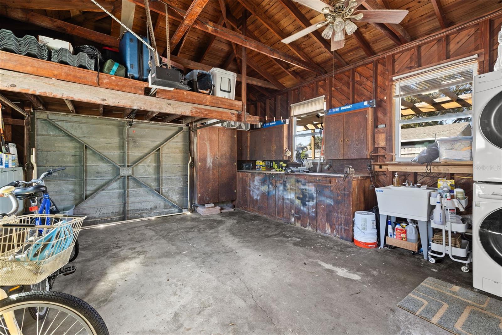 Dedicated workspace featuring extensive built-in cabinetry and workbench areas, ideal for hobbies, projects, or organized tool storage. Classic wood detailing adds character to this highly usable space.