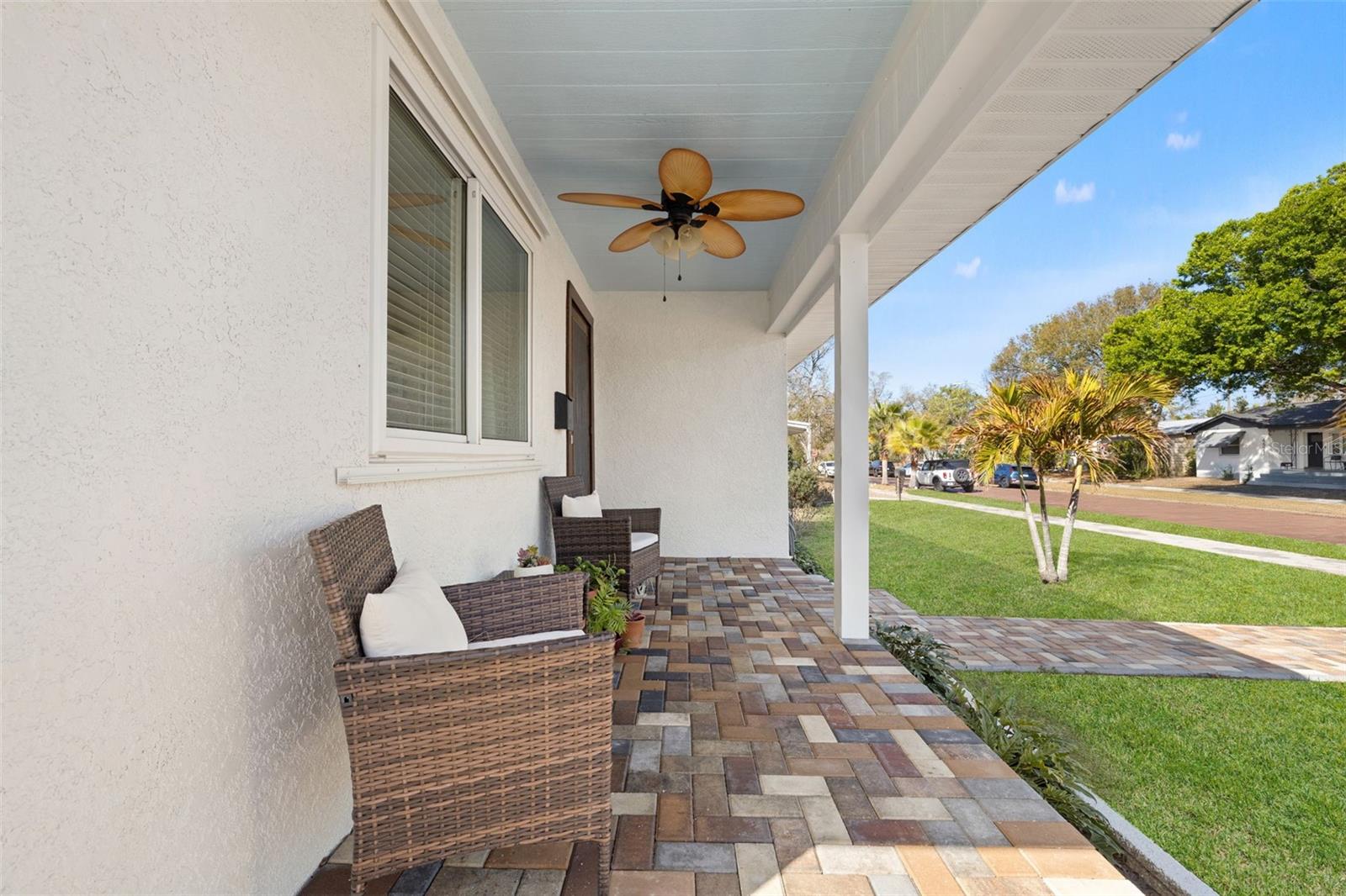 Covered front porch overlooking brick street—ideal for morning coffee or evening seating.