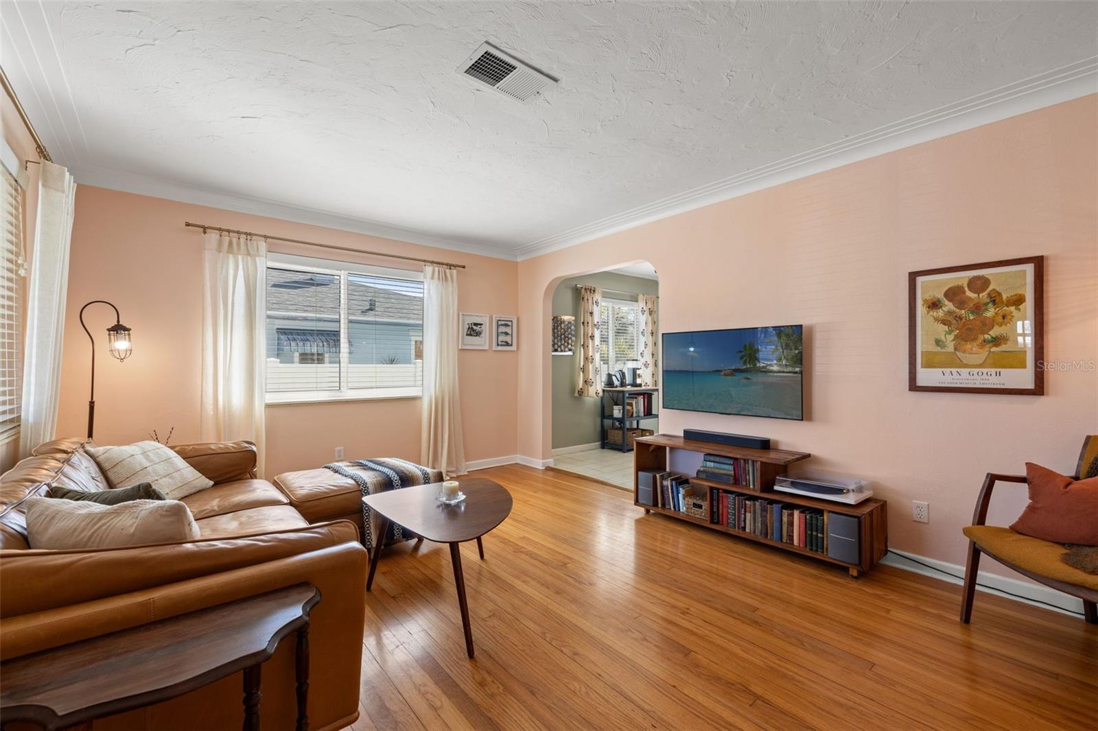 Living room with original hardwood floors and natural light.