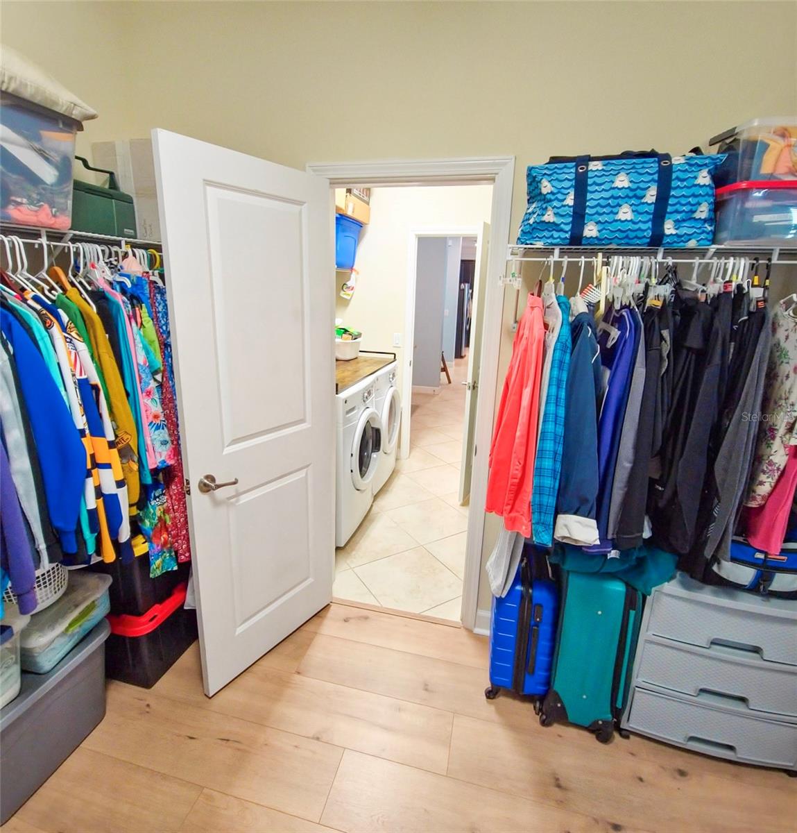 Primary walk-in closet view of laundry room