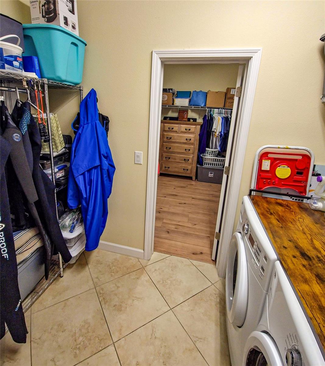 view into Primary walk-in closet from laundry room