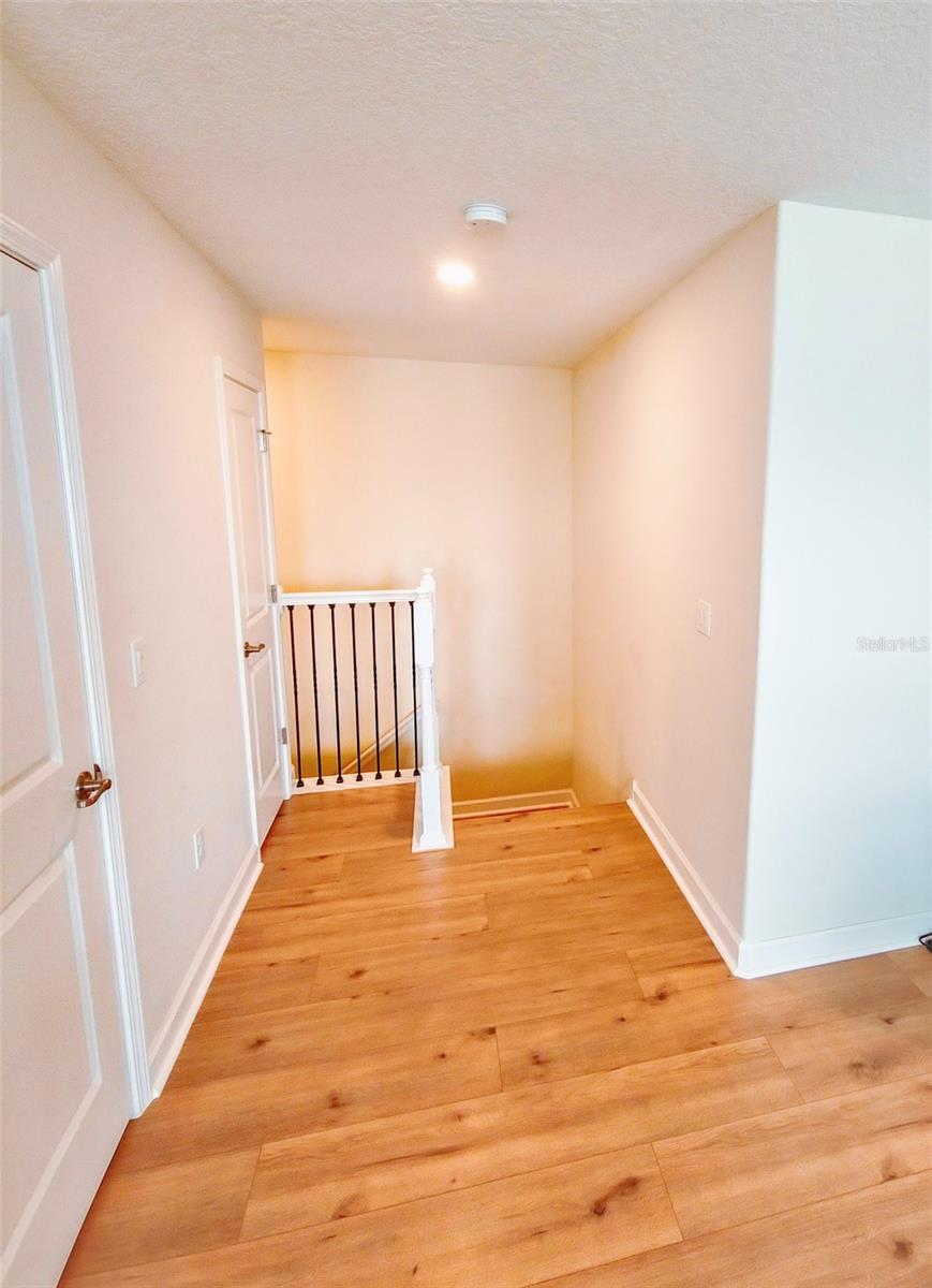 Upstairs landing area with two storage closets at the left