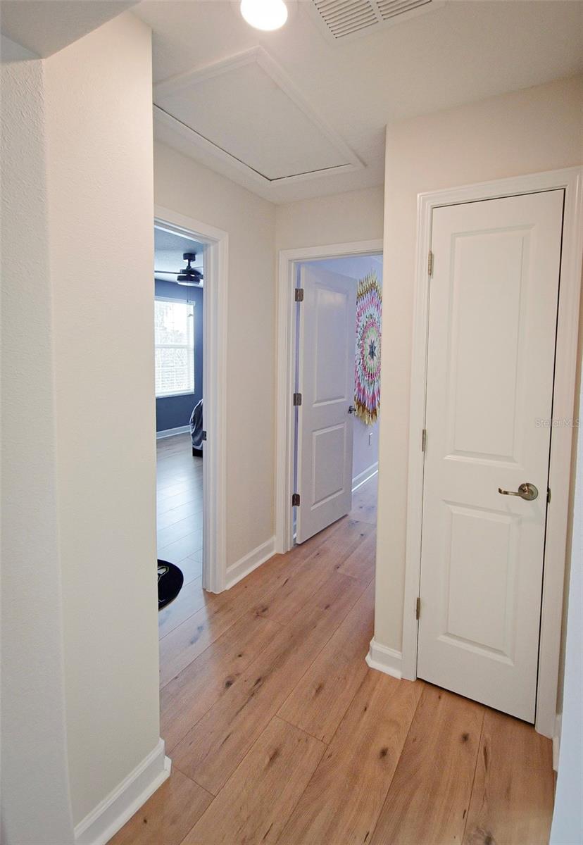 Hall leading to the other two bedrooms and fourth bathroom