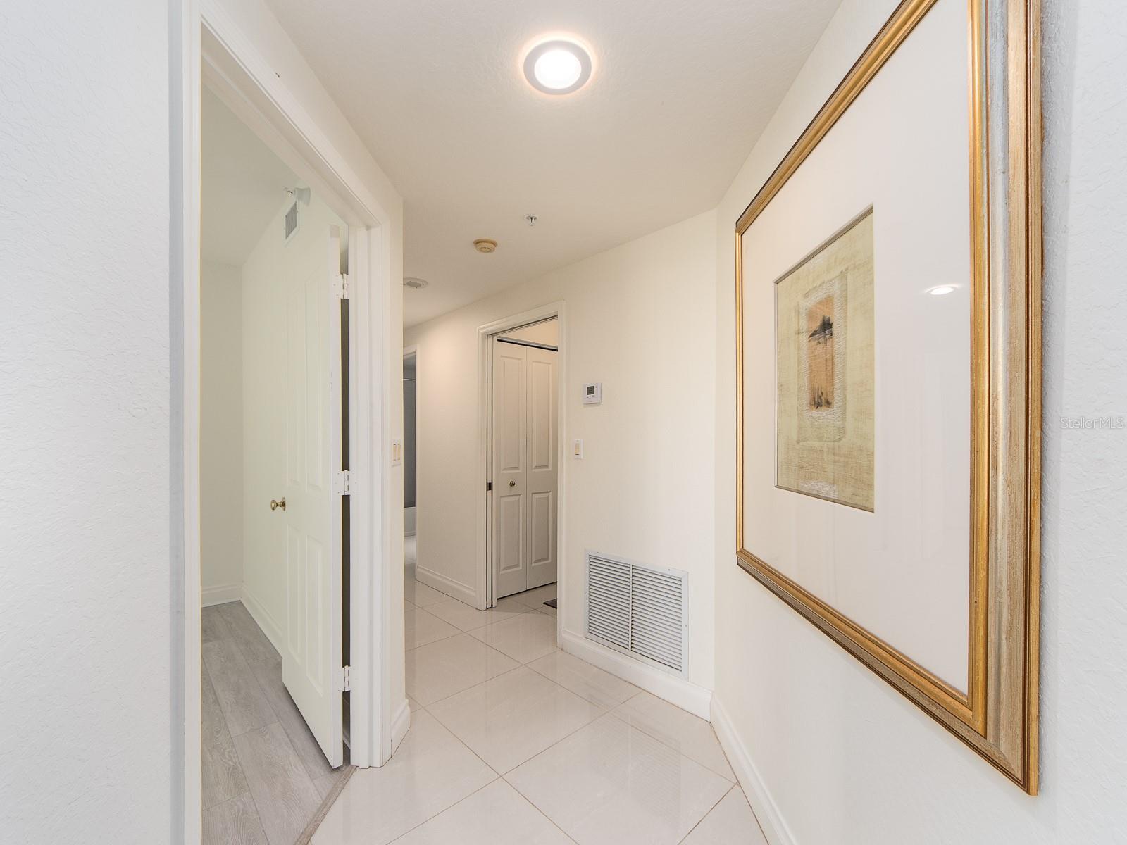 Hallway leading to 2 other guest rooms, laundry room and guest bathroom.