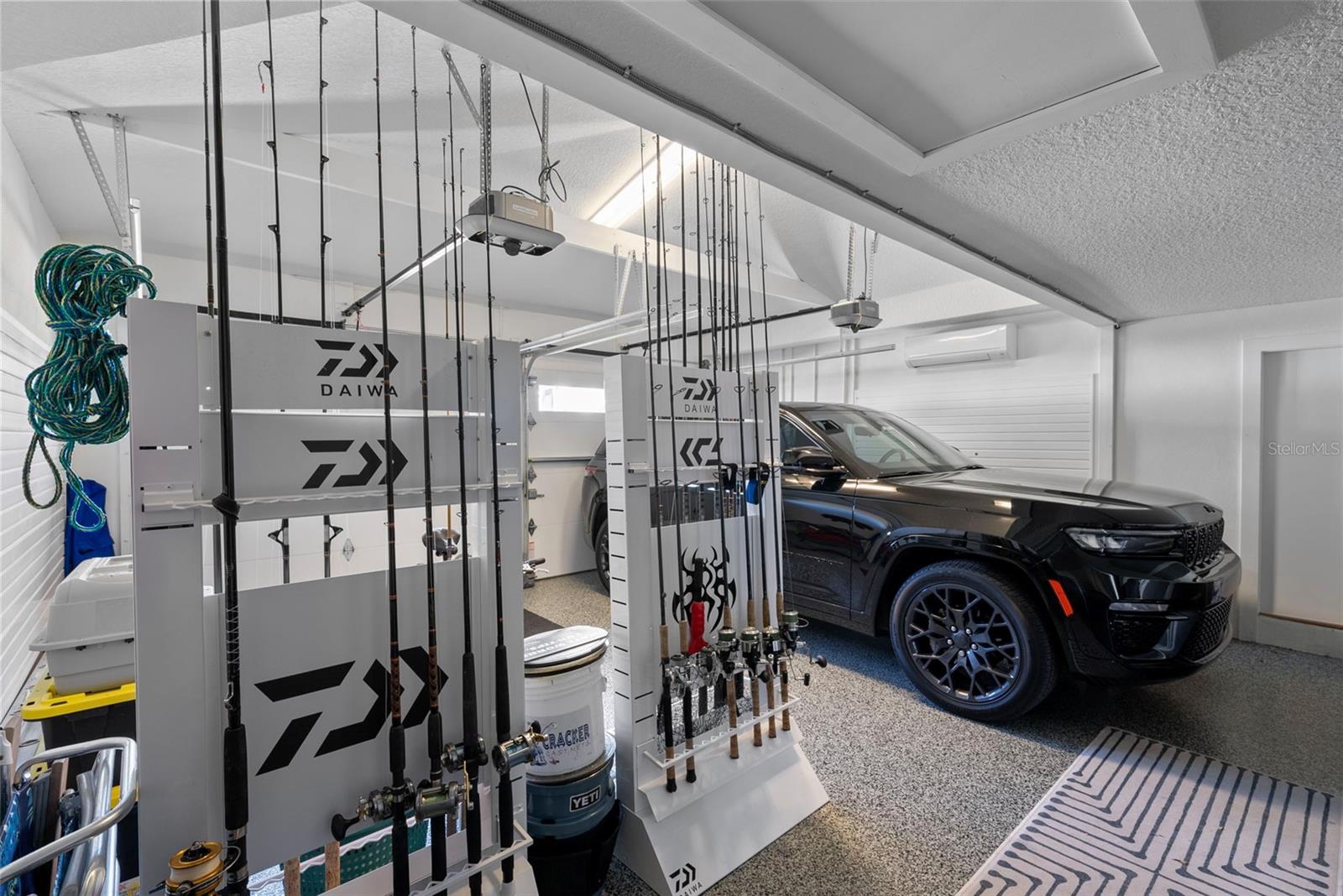 The garage has a mini-split AC, storage and epoxy flooring