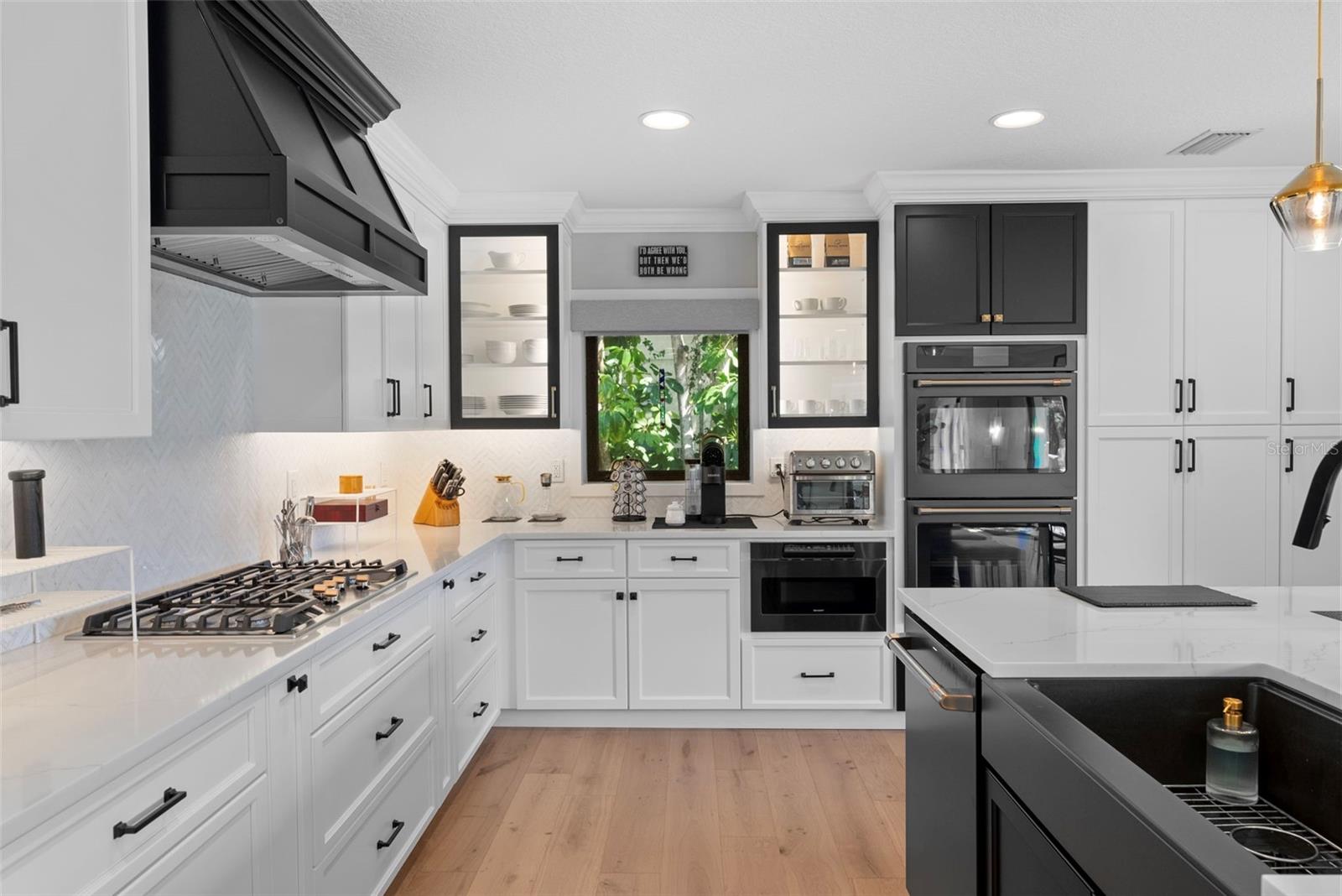 featuring custom cabinetry, quartz countertops, and ample storage