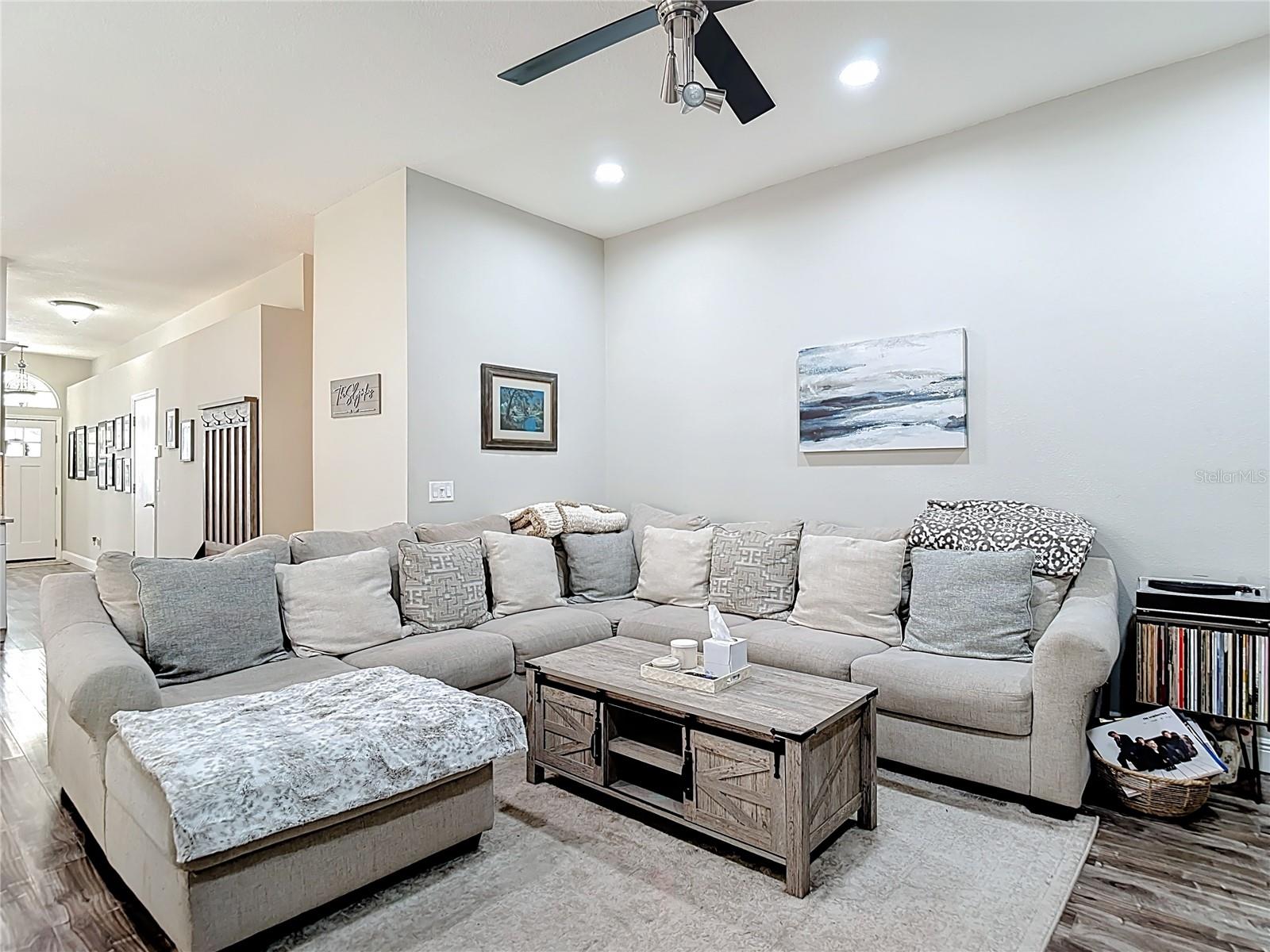 The family room features a charming wood-burning fireplace updated with white marble tile in a beautiful herringbone pattern — creating a warm and inviting focal point.