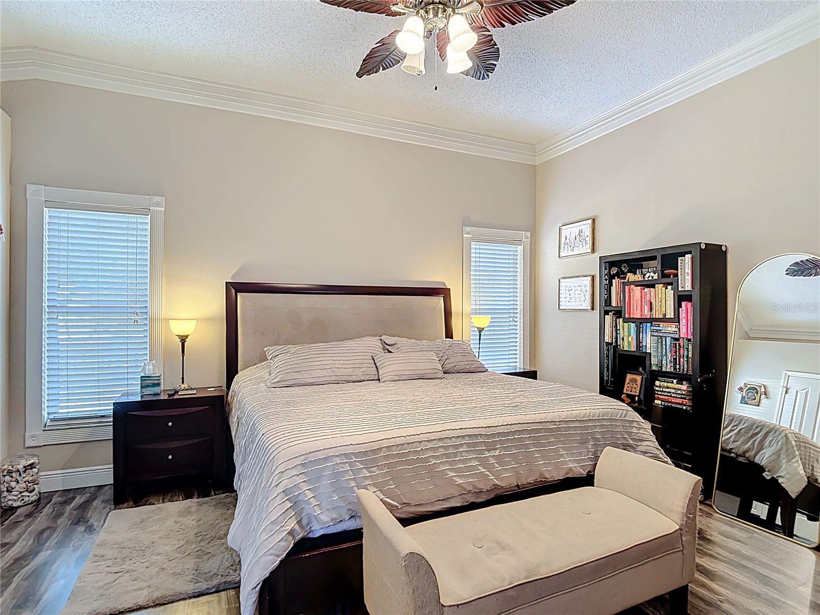 The spacious primary suite includes a walk-in closet and an en-suite bathroom with granite countertops, double sinks, and a walk-in shower.