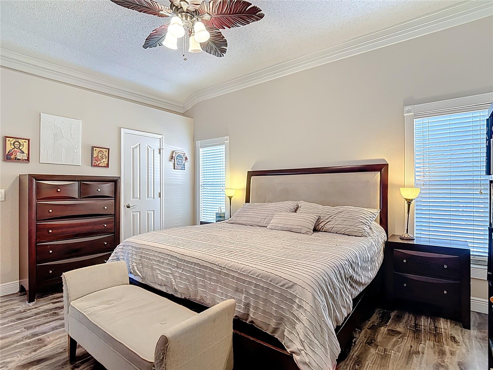 The spacious primary suite includes a walk-in closet and an en-suite bathroom with granite countertops, double sinks, and a walk-in shower.