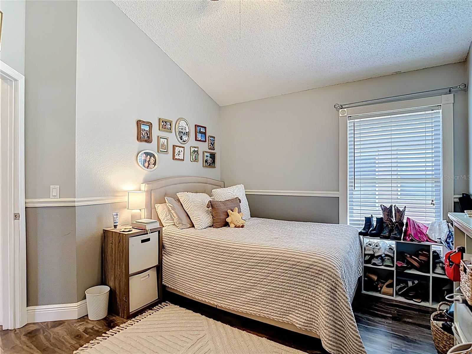 Generously sized Bedroom 3 feature vaulted ceilings, and a walk-in closet.