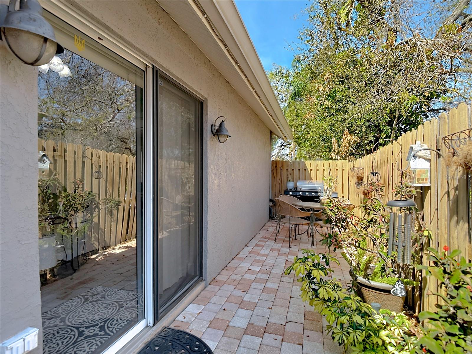 Enjoy the back & side patio for your morning coffee and the newly poured back patio (2024), perfect for gatherings and outdoor entertaining.